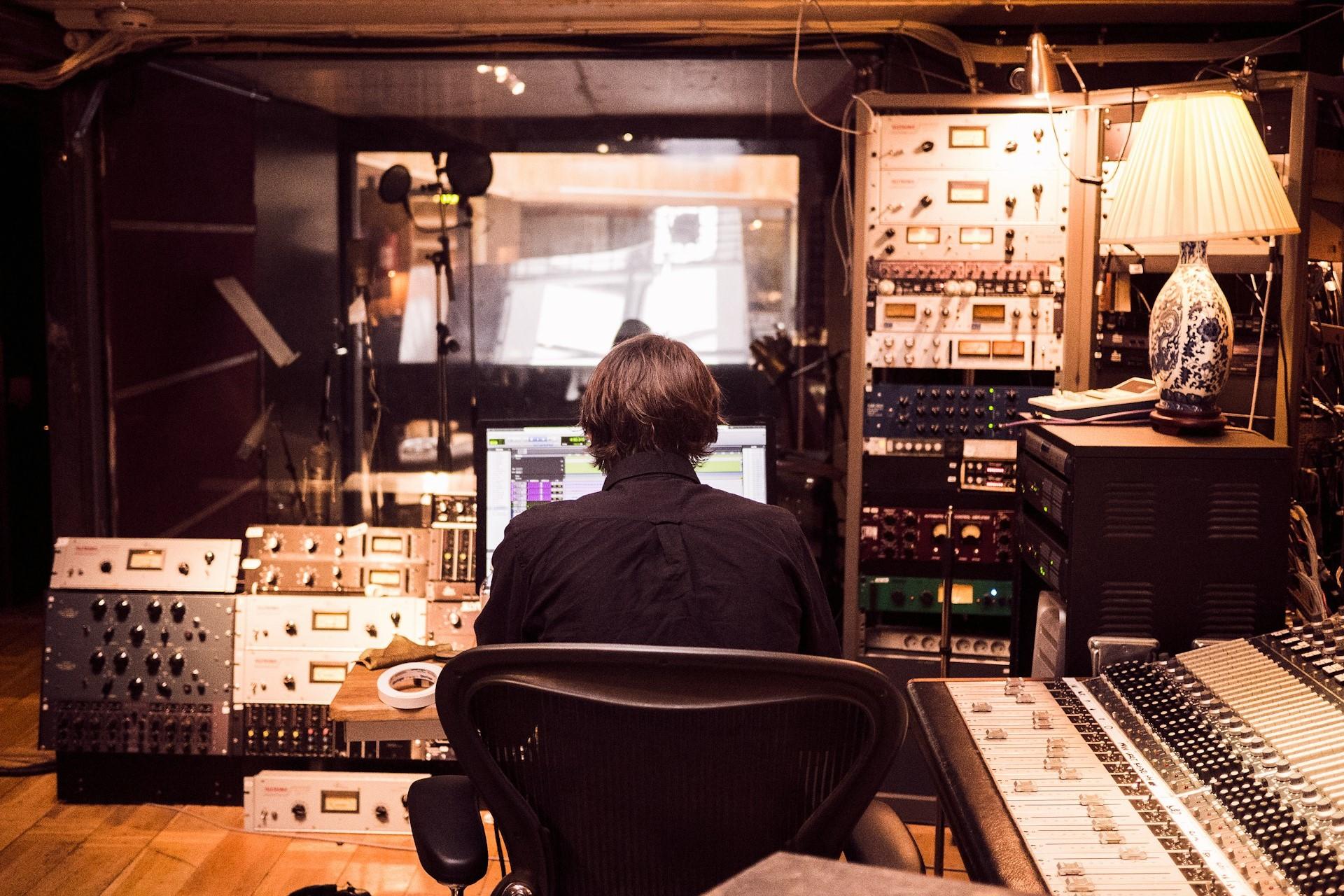 A man working in a recording studio.