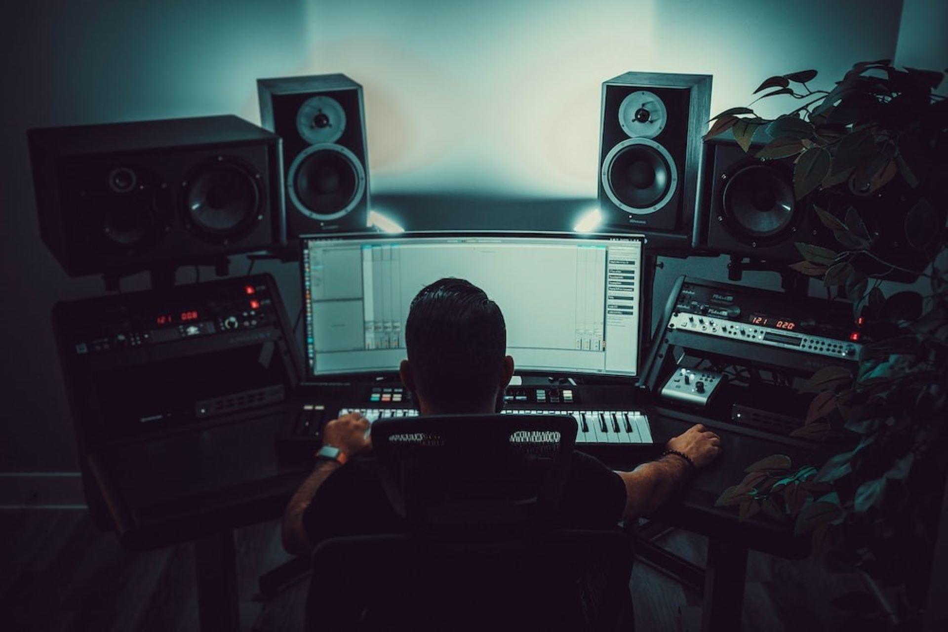 A music producer working on a song in a studio