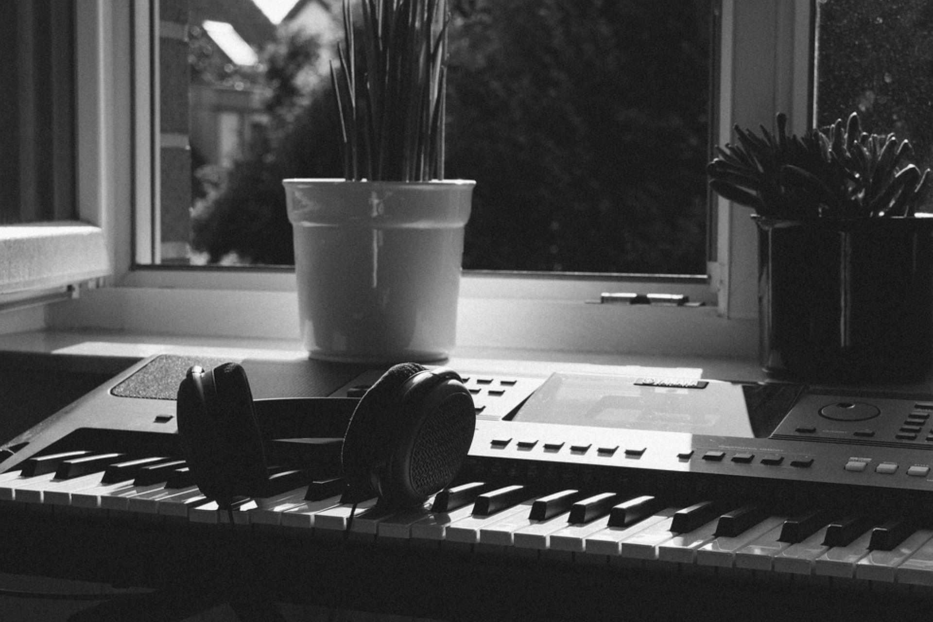 A set of headphones placed on a piano