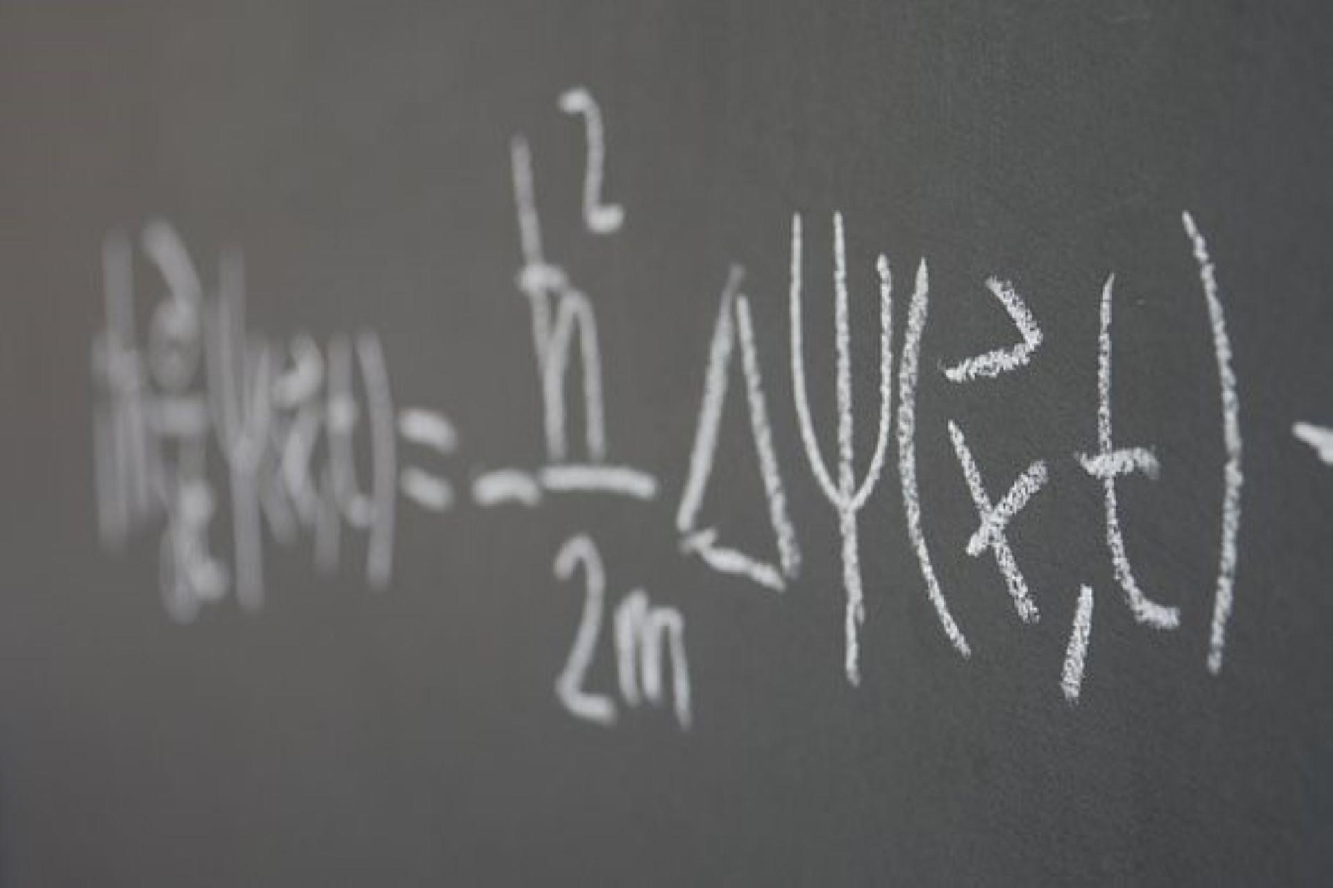 A mathematical equation written on the board.