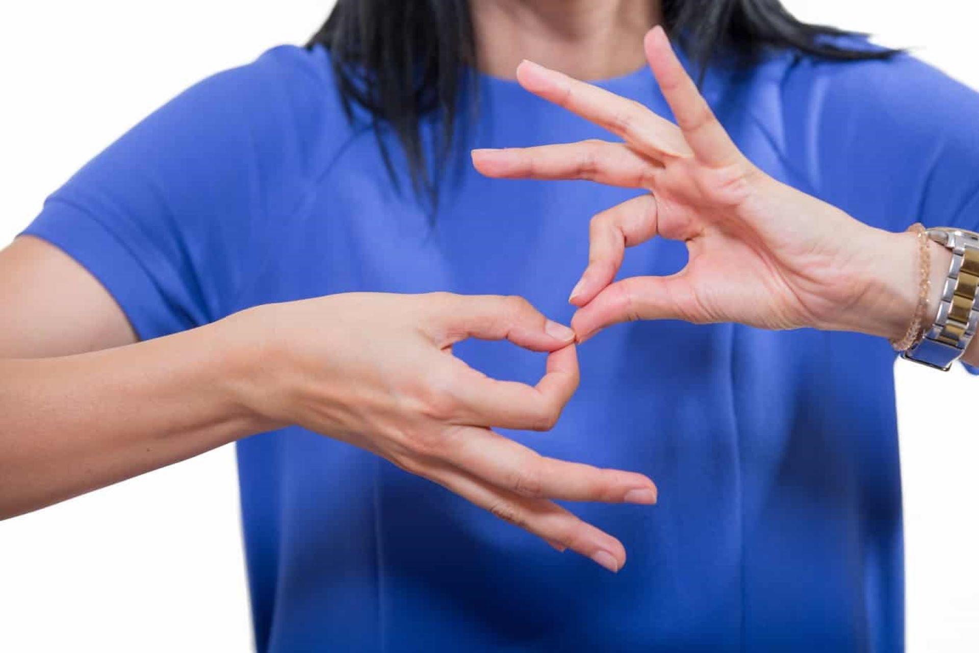 A person making a sign language gesture.