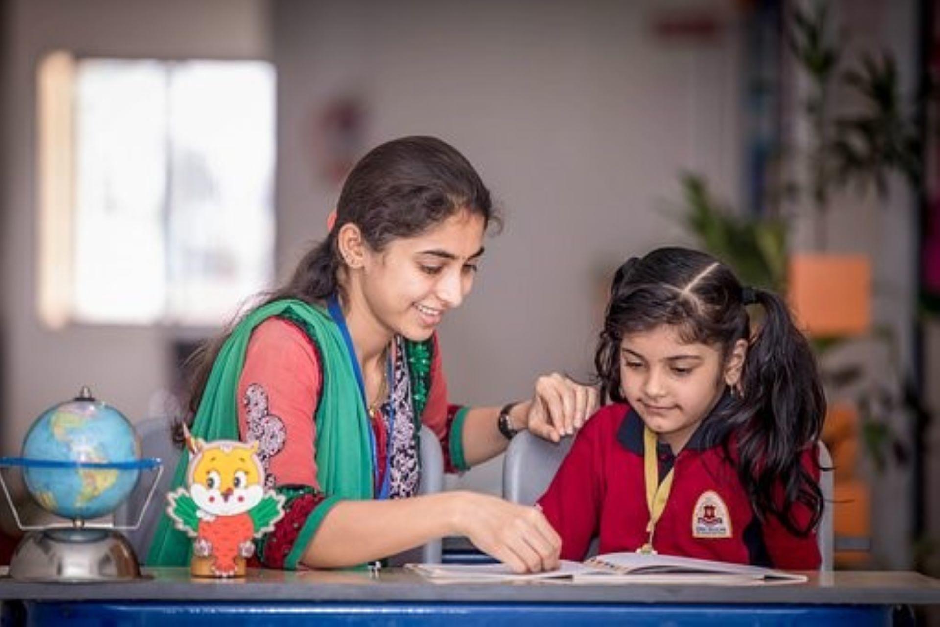 A tutor privately teaching a student. 