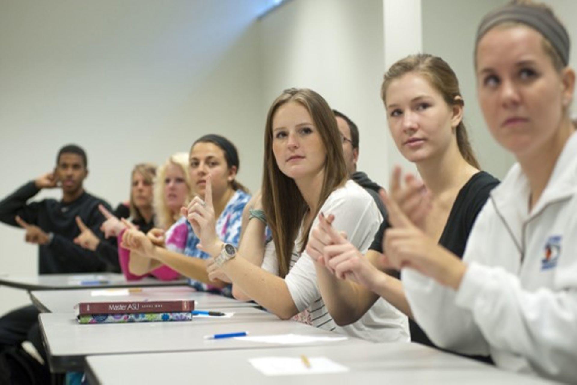 A group of students during a sign language class.