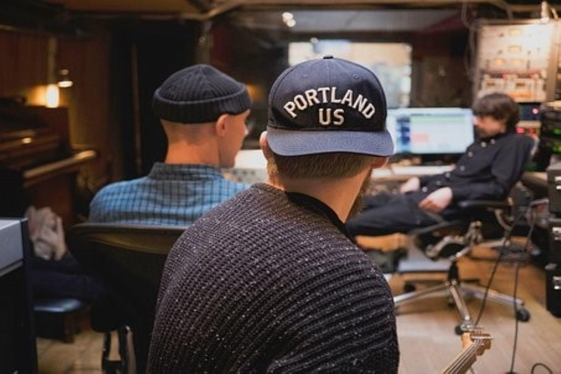 A group of record music producers working on a song.