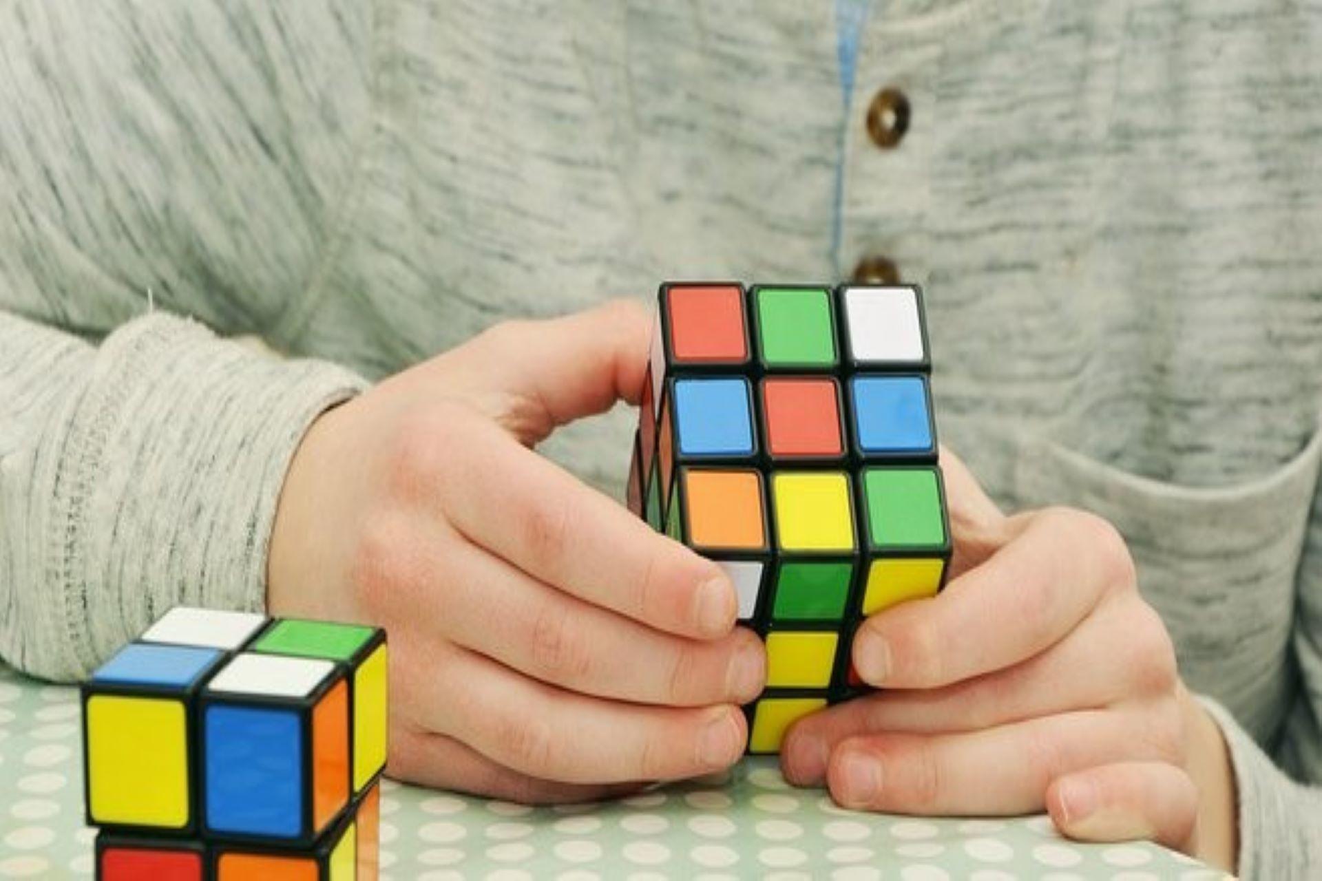 A person playing with the cube.