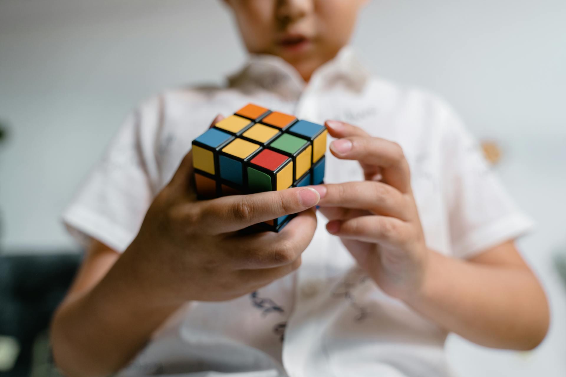 a child playing with a Rubik's Cube