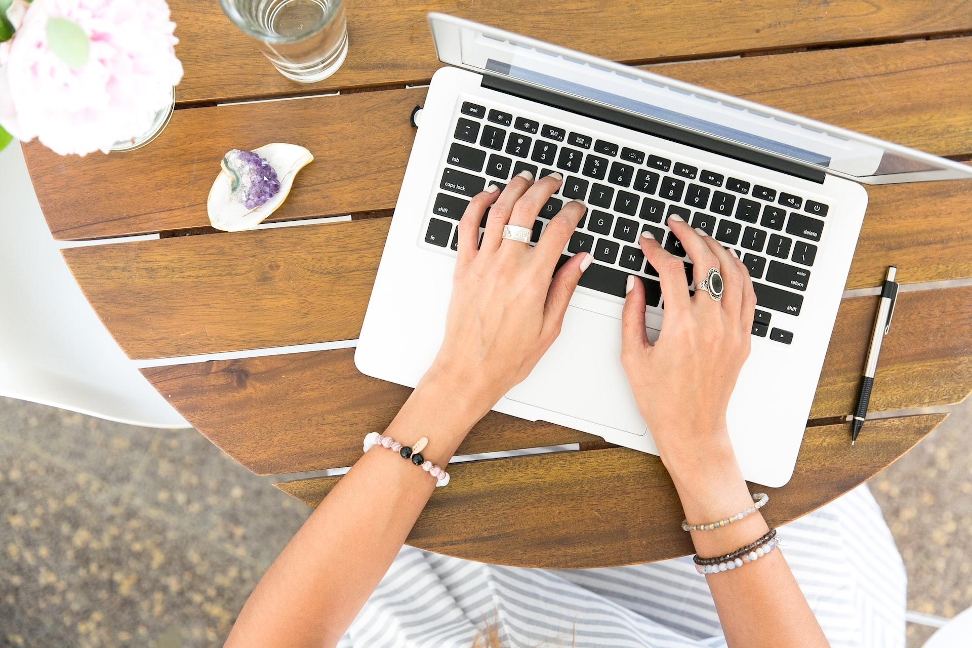 A person typing on a laptop computer