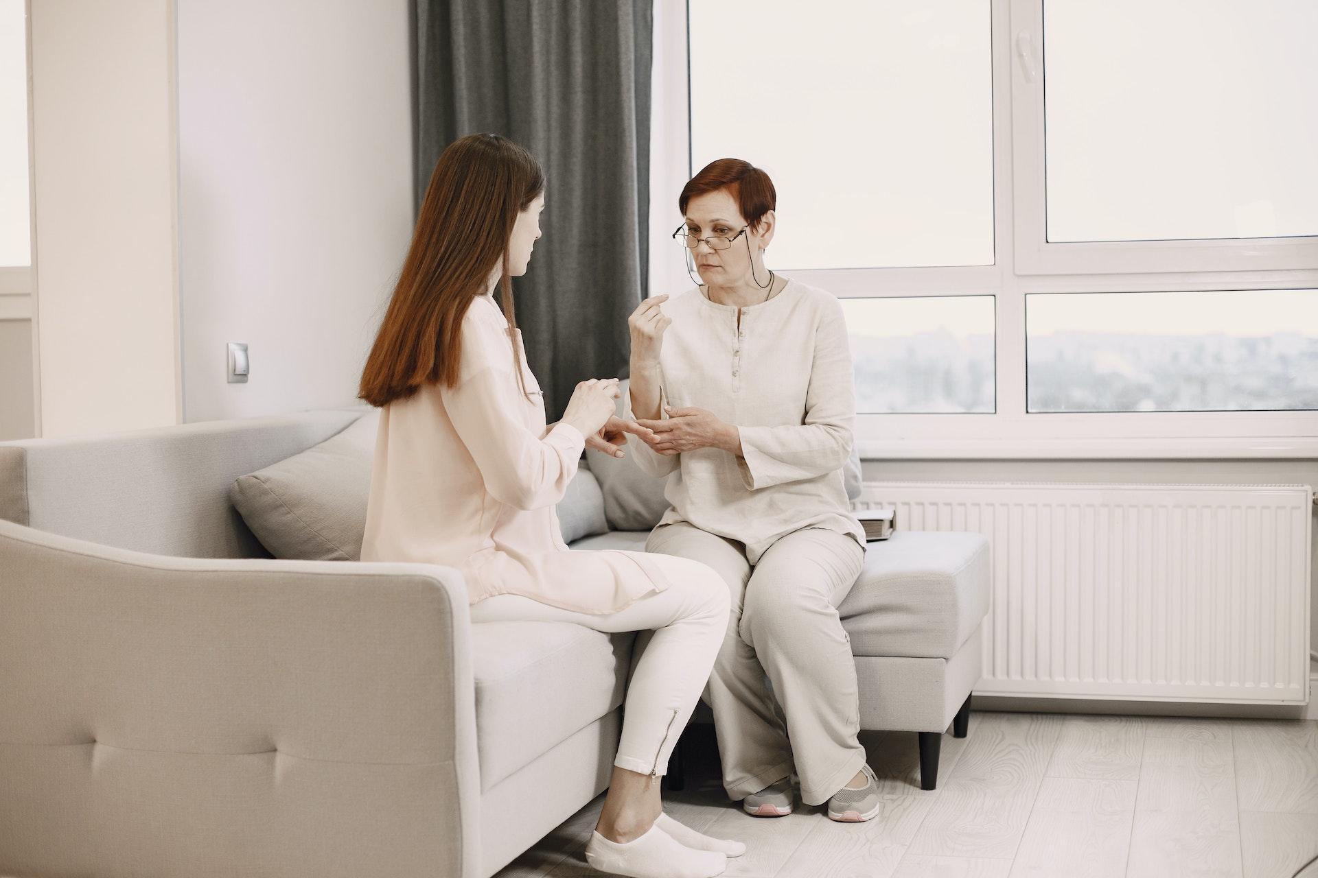 A sign language instructor teaching a student