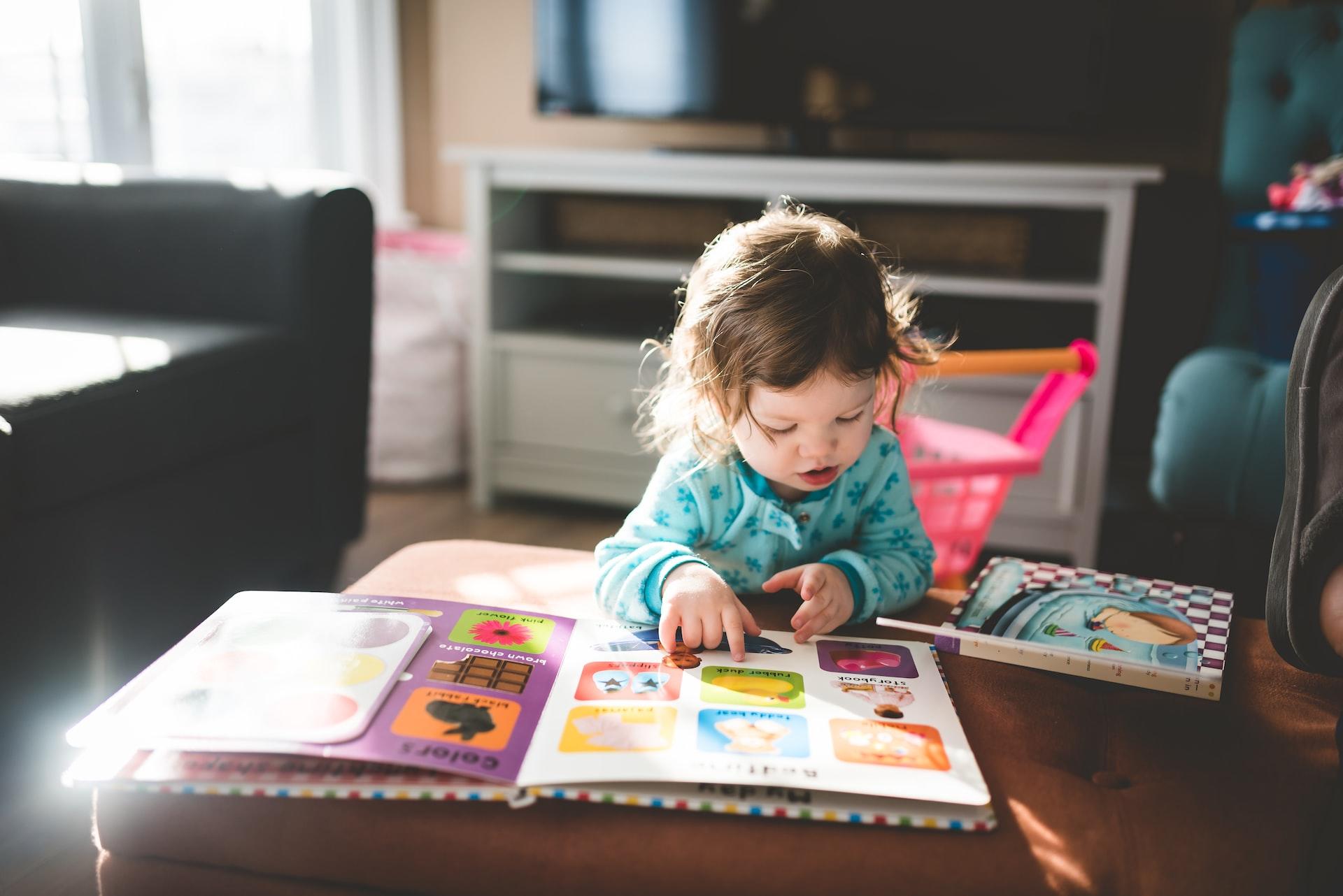 young multilingual child reading and observing