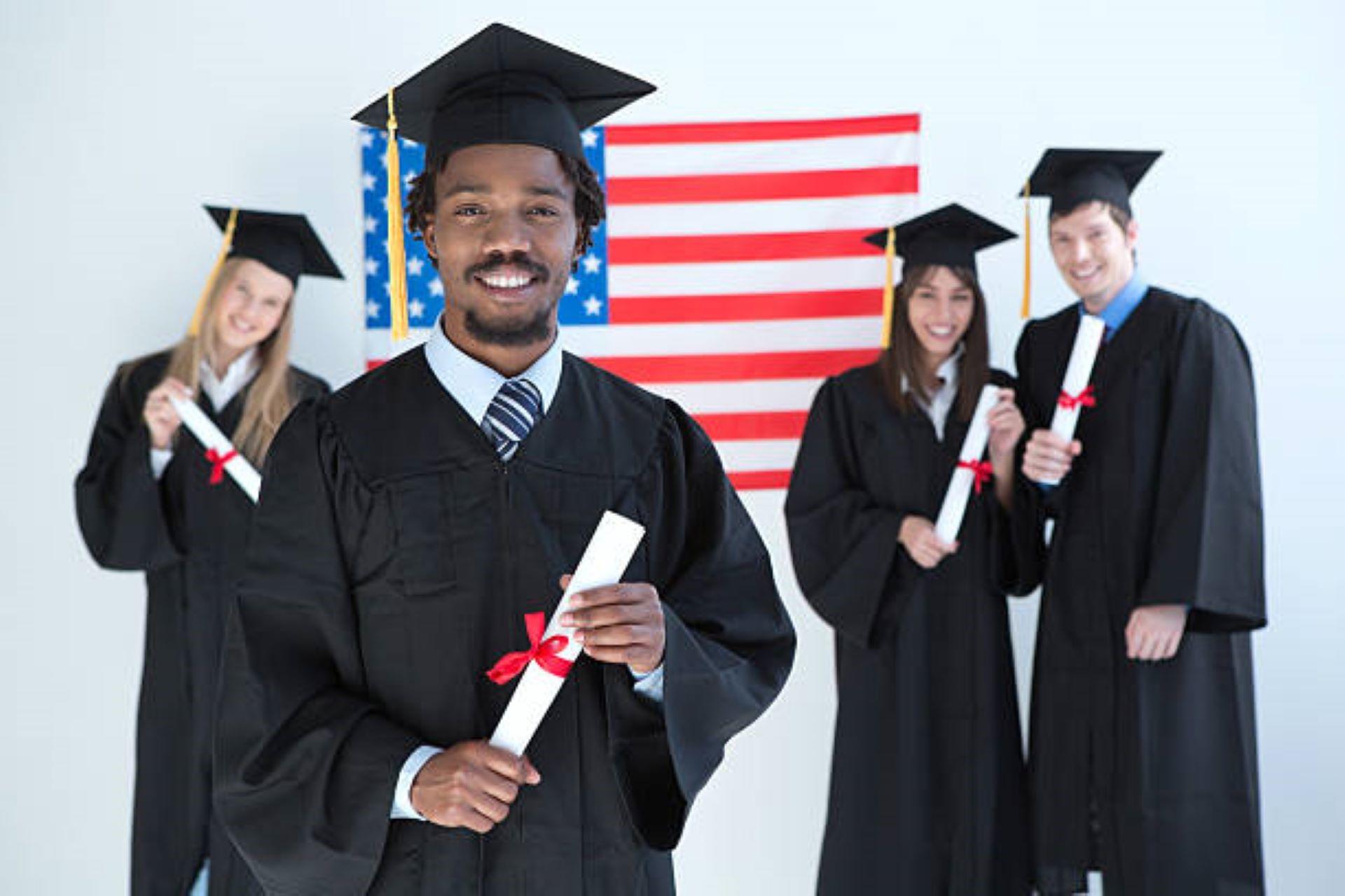 A group of African American graduates holding their degree