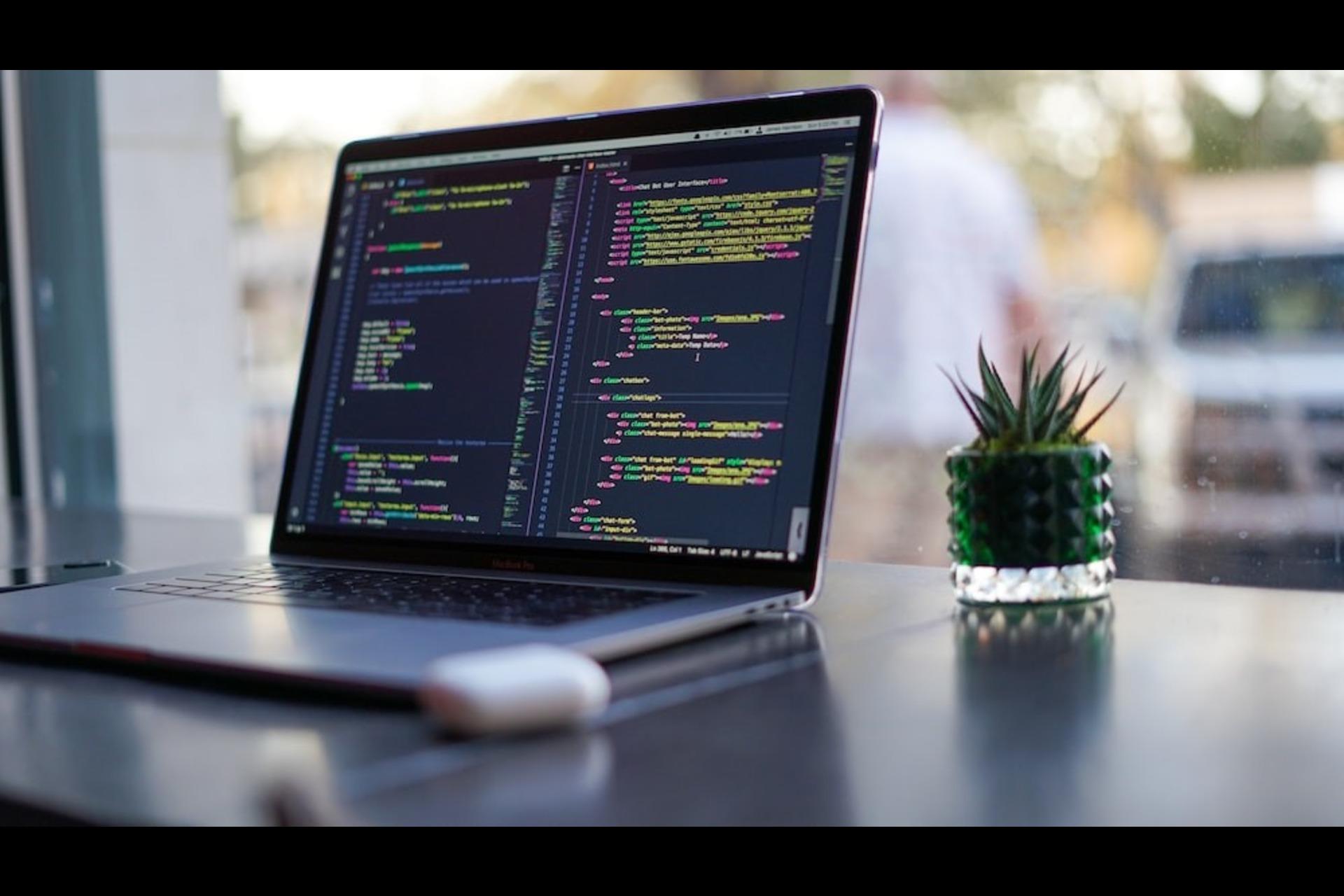A laptop screen displaying the source code of a programming language. 