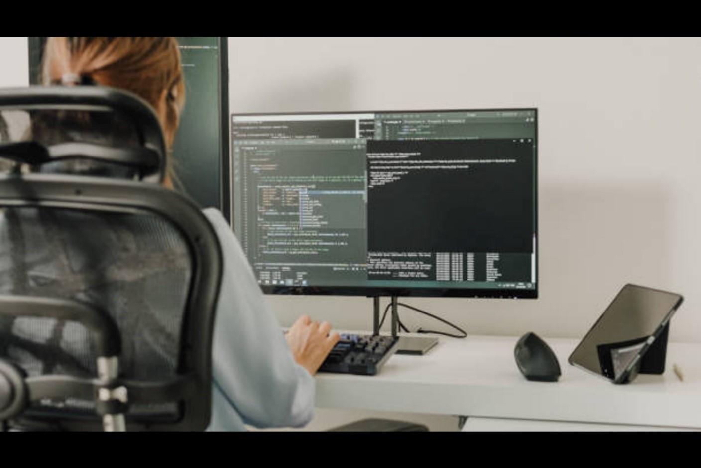 Software developer writing code on a computer