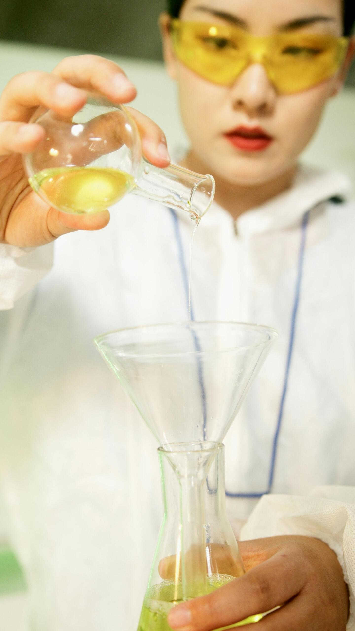 A woman conducting a scientific experiment in a laboratory.