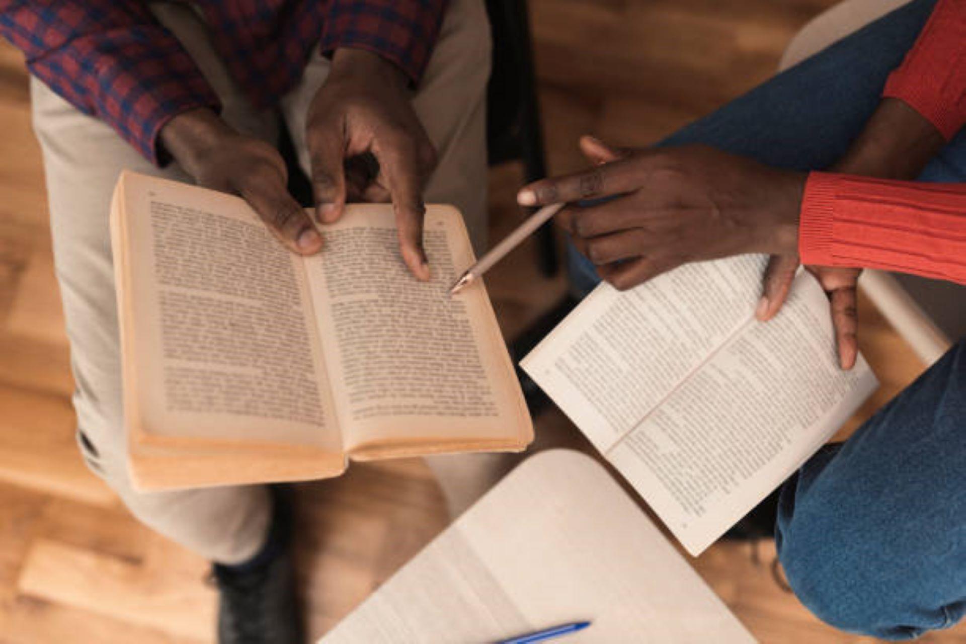 African American students reading a book together