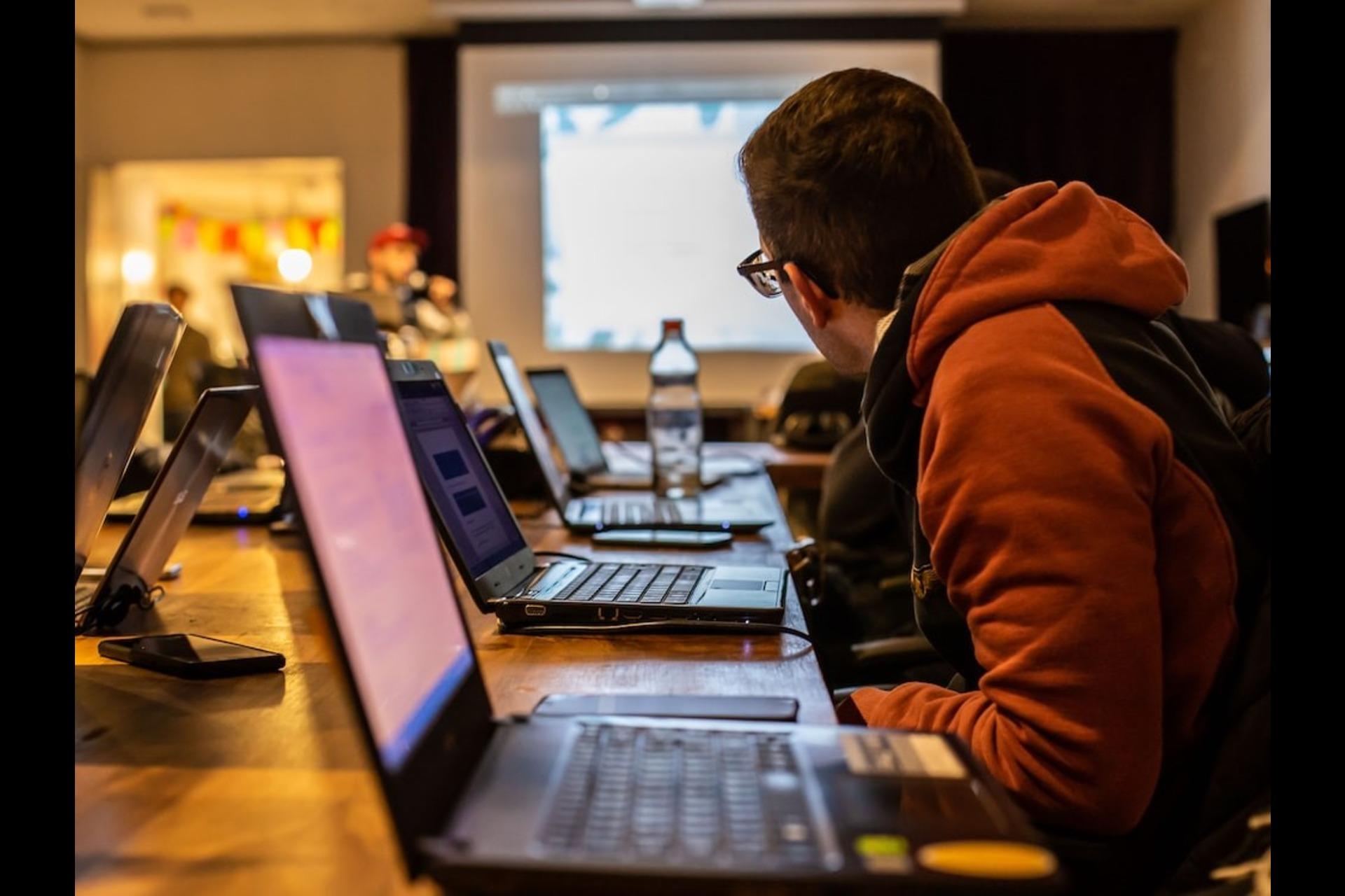A student with a laptop during a class.
