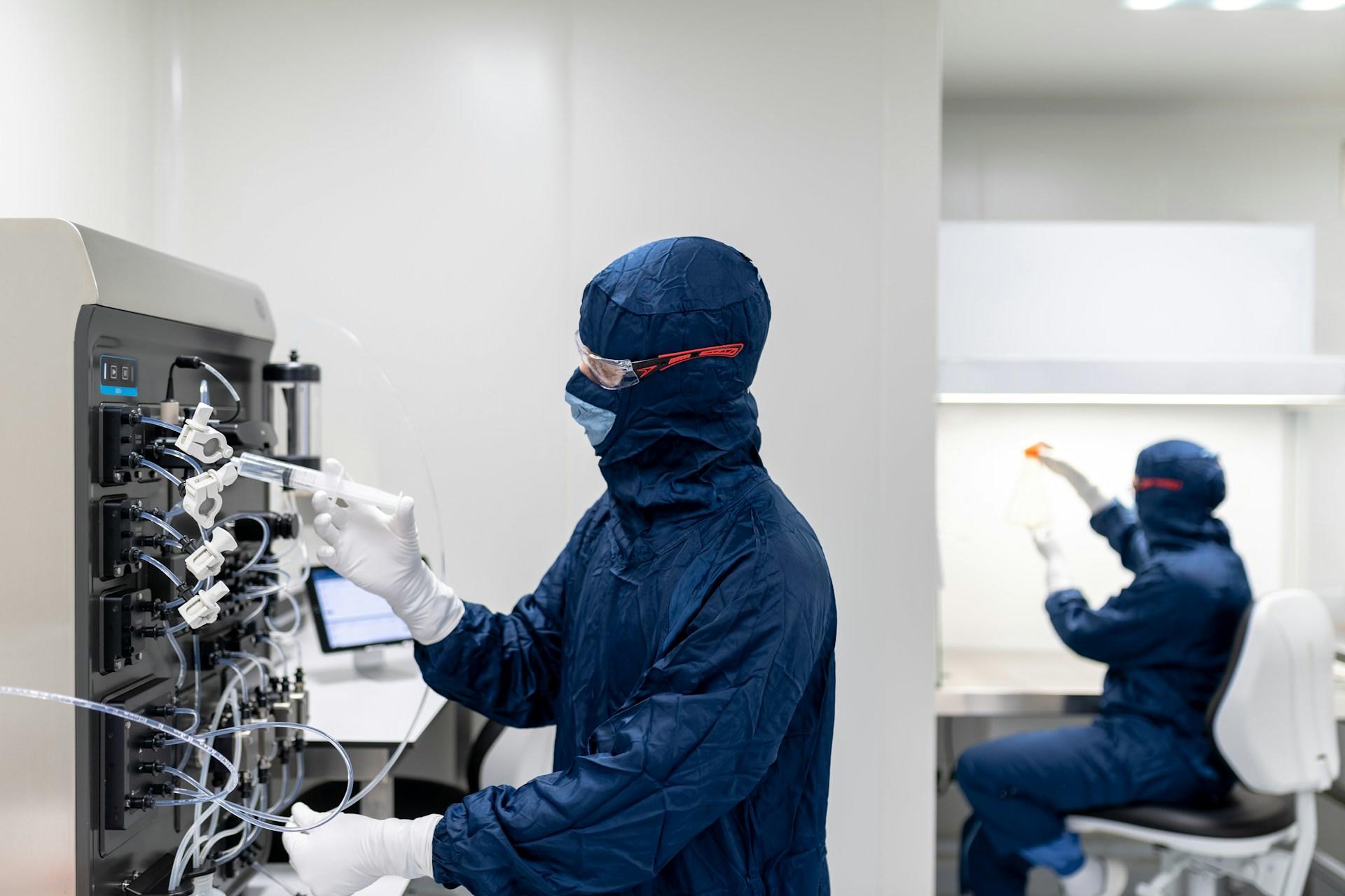 Scientists working in protective clothing.