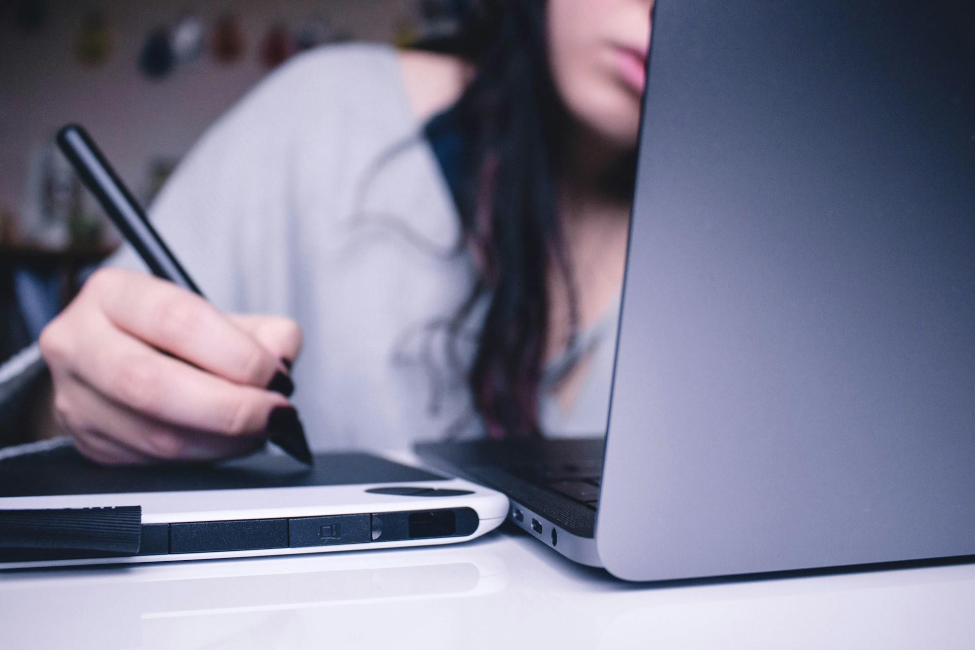A student looking at a laptop screen.