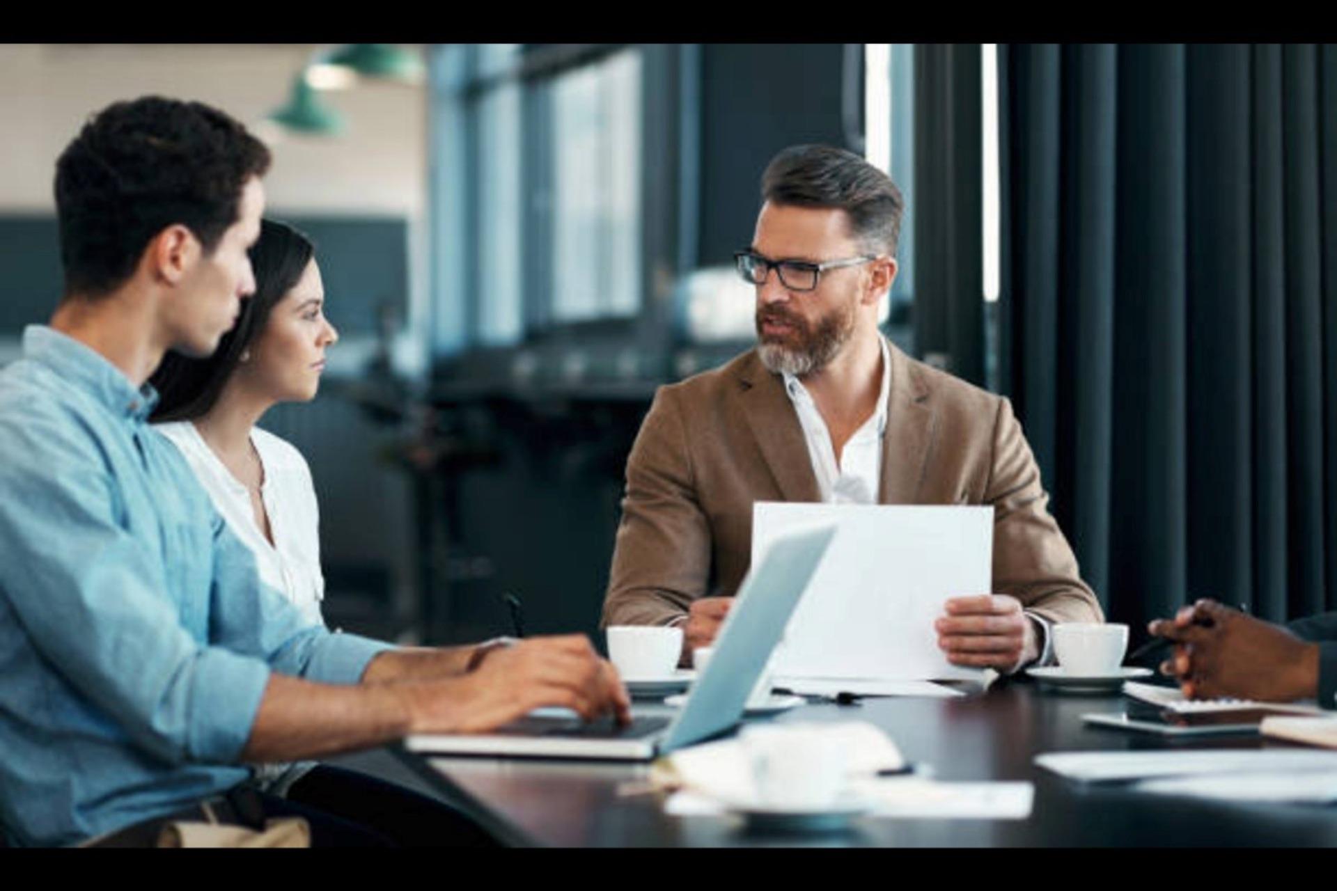 Management discussing the project with the leader.