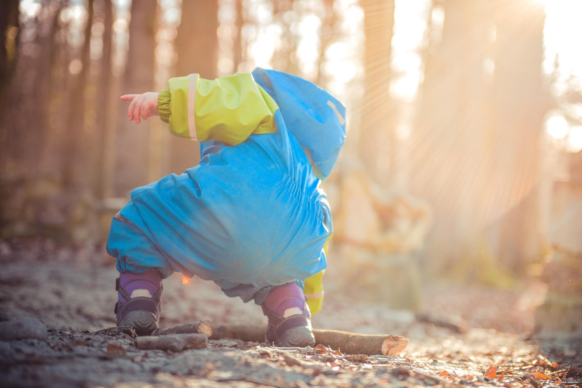 Little boy hiking with his parents.