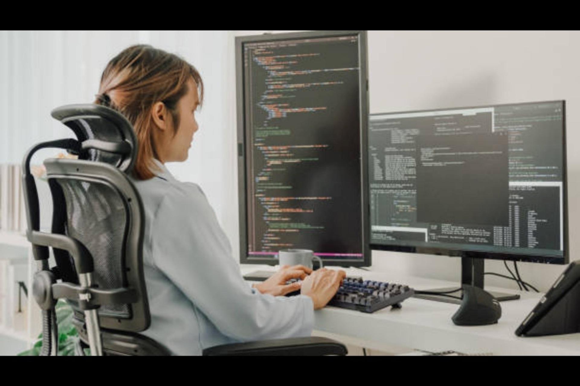 A woman using a computer to program