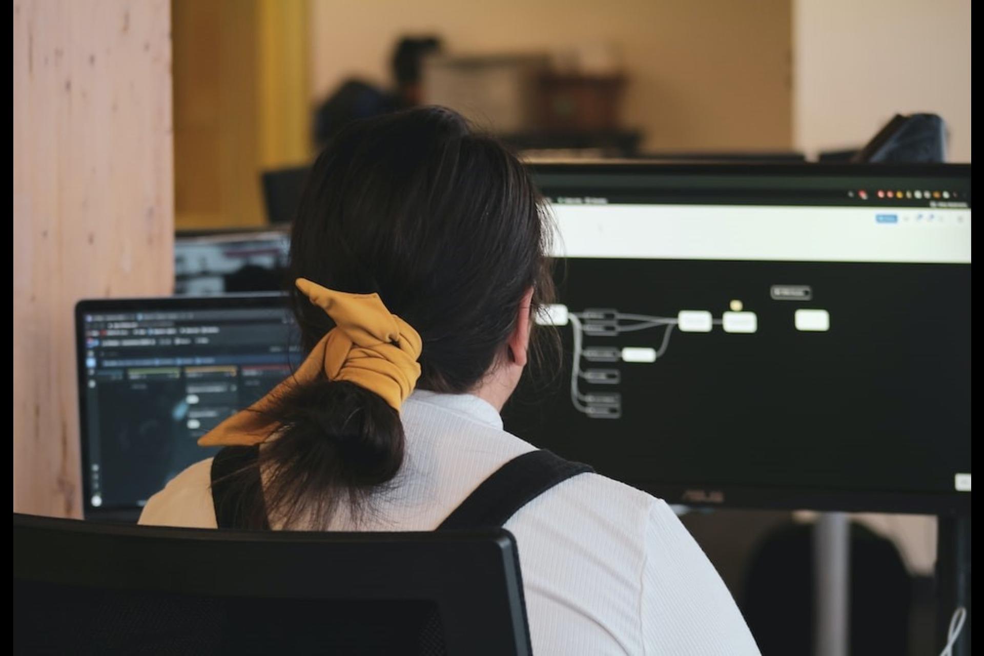A cloud engineer working on a computer.