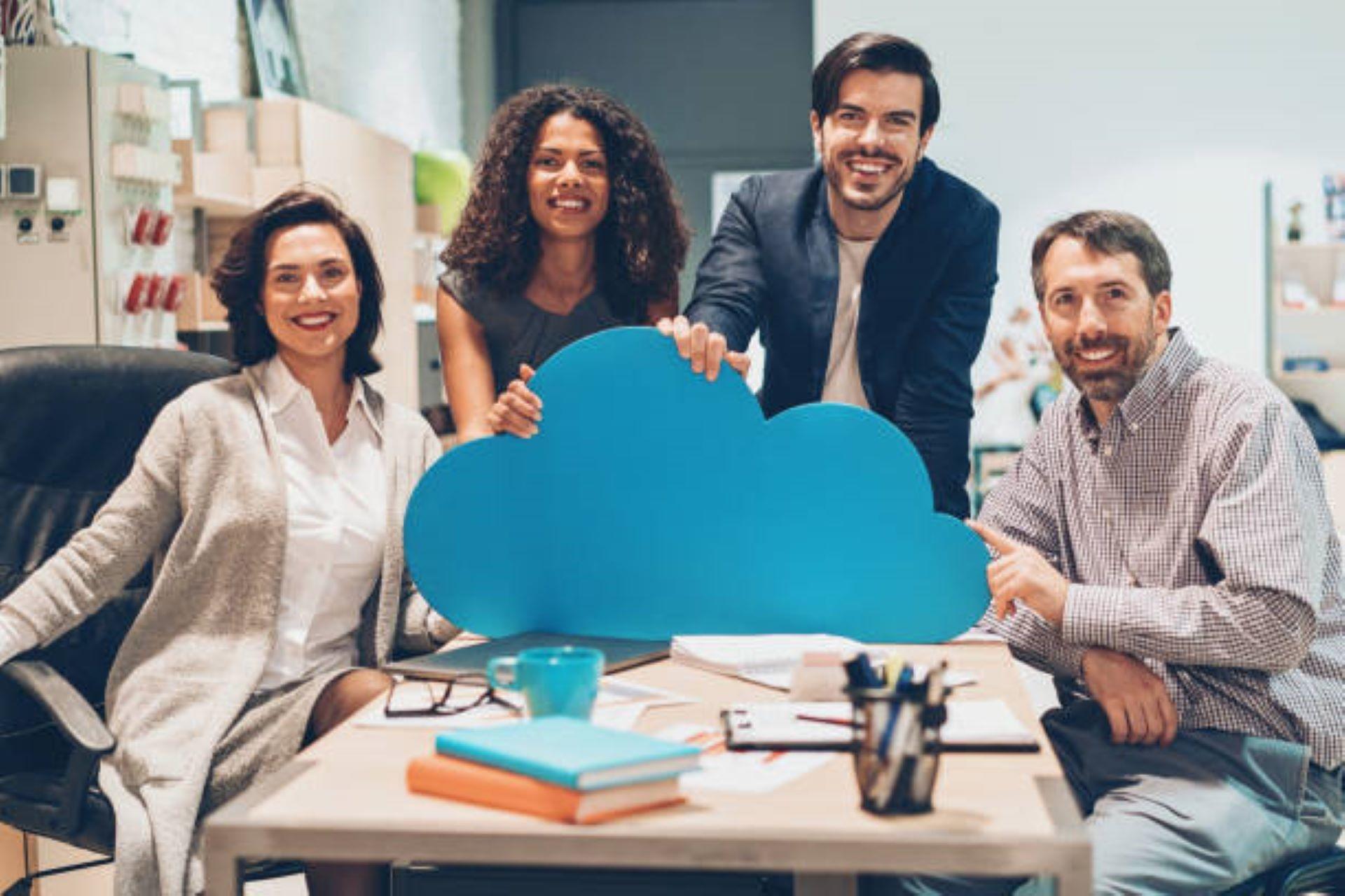 Cloud engineers holding a blue cloud