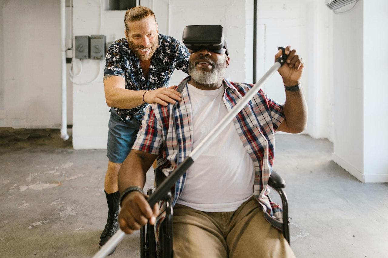 A man in a wheelchair uses a VR headset to simulate a kayaking trip