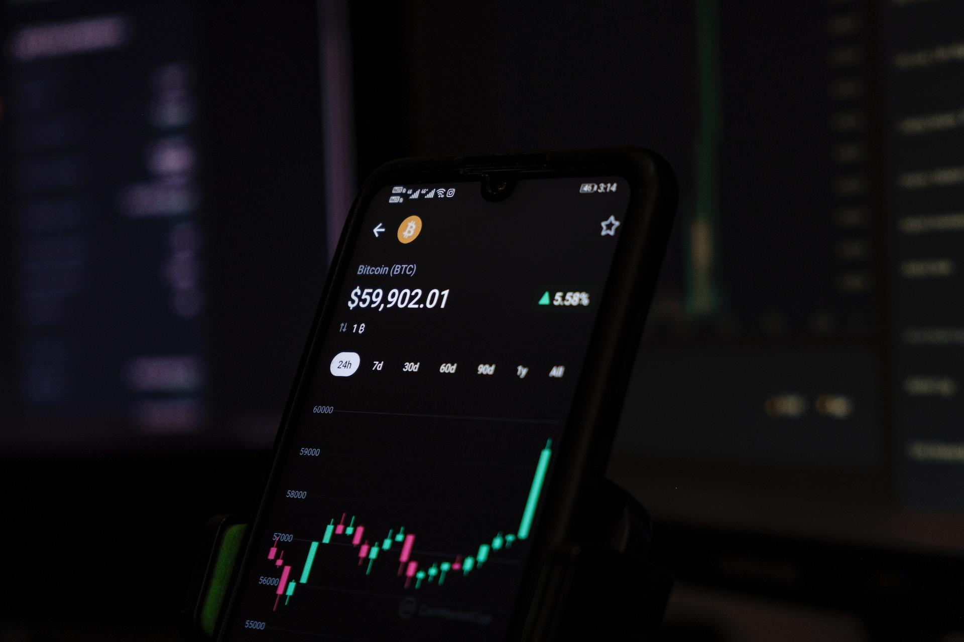 A cell phone displaying the price of Bitcoin.