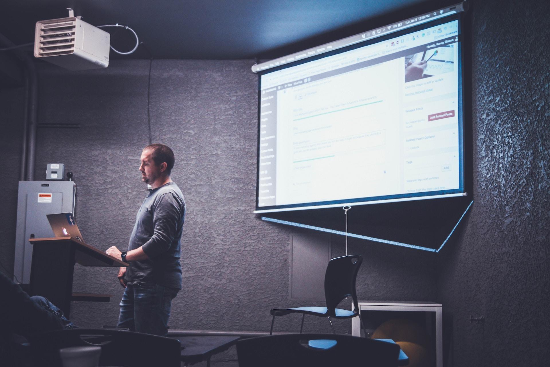Teacher in class with projector.