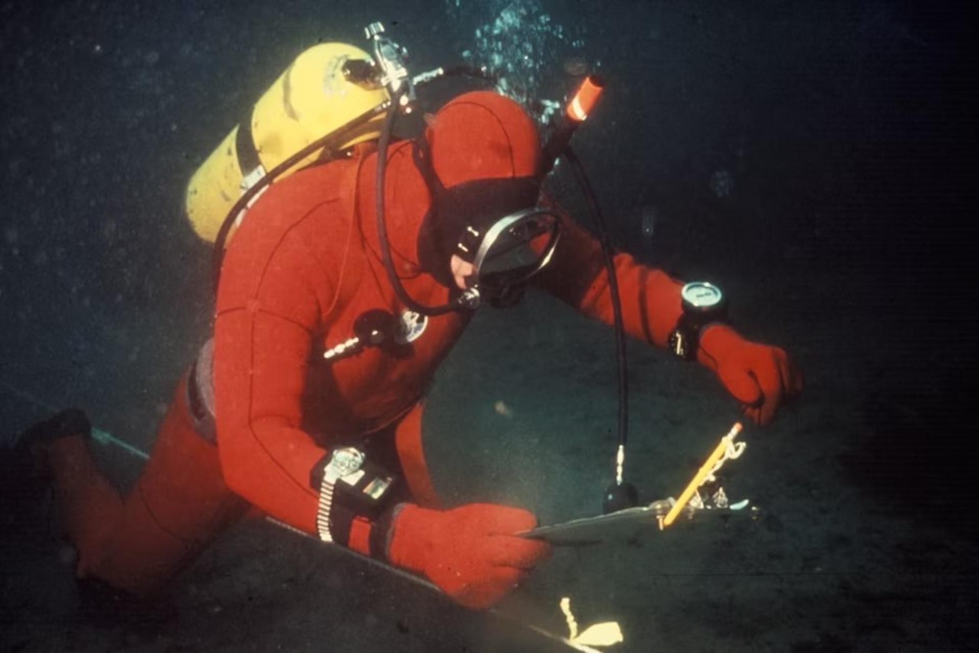 A marine biologist collecting samples under the water