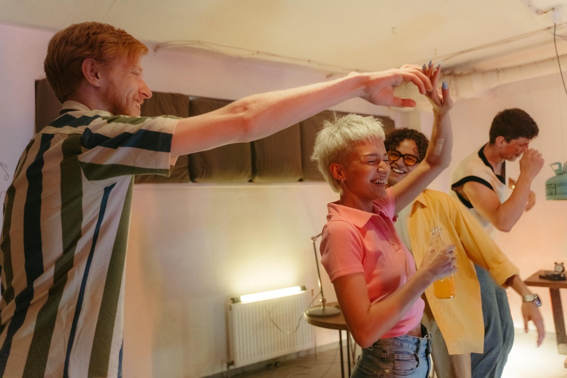 Teens having fun and dancing at a house party.