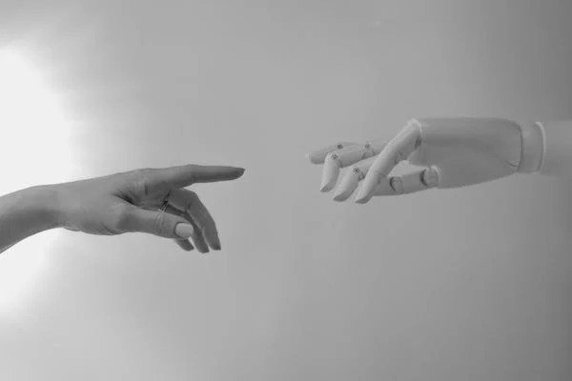 Human and robot hands reaching out
