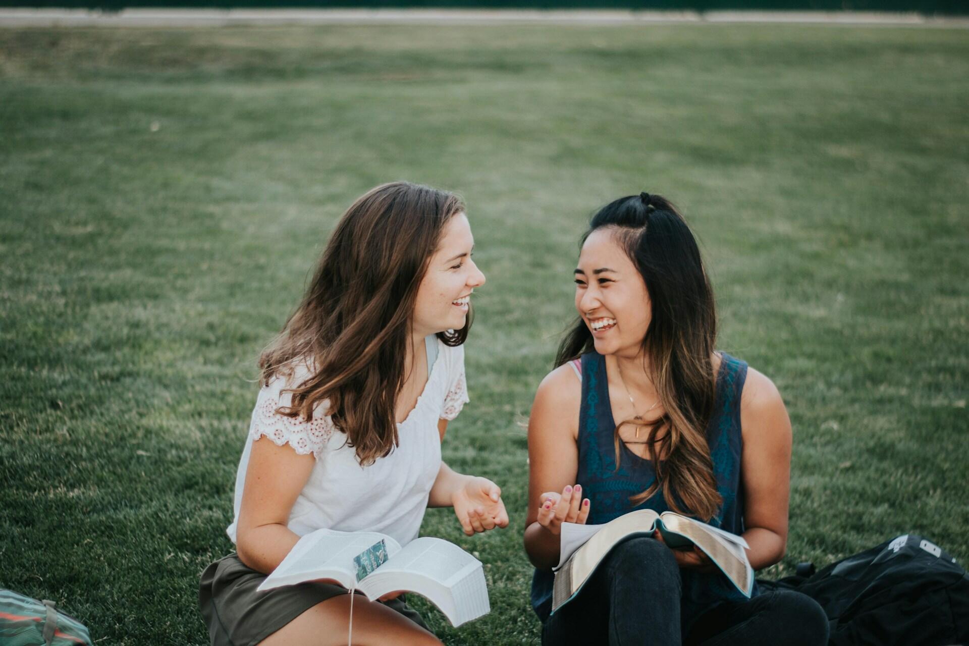 Two students studying together outdoors.