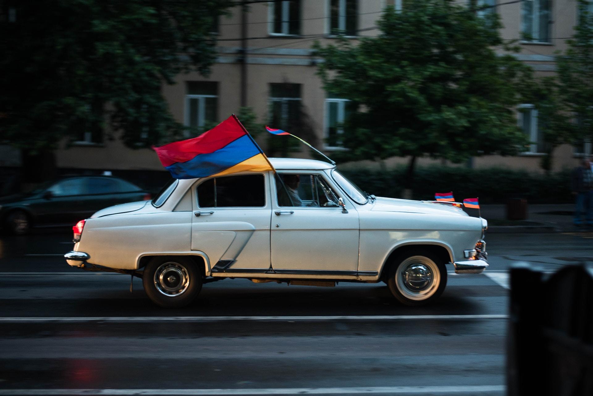 Moving car with Armenian flag.