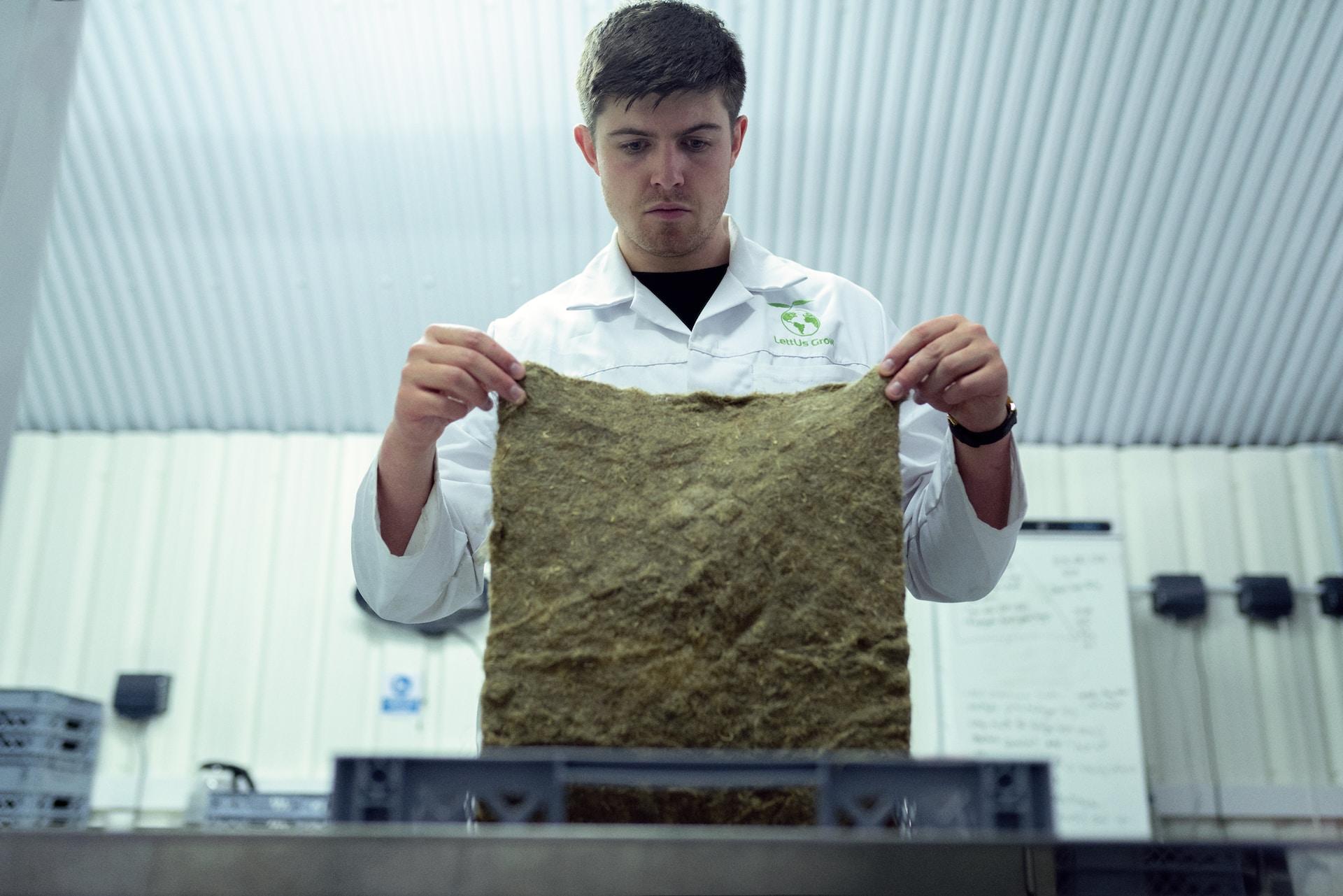 A scientist holding the seed-growing paper-like material he helped develop.