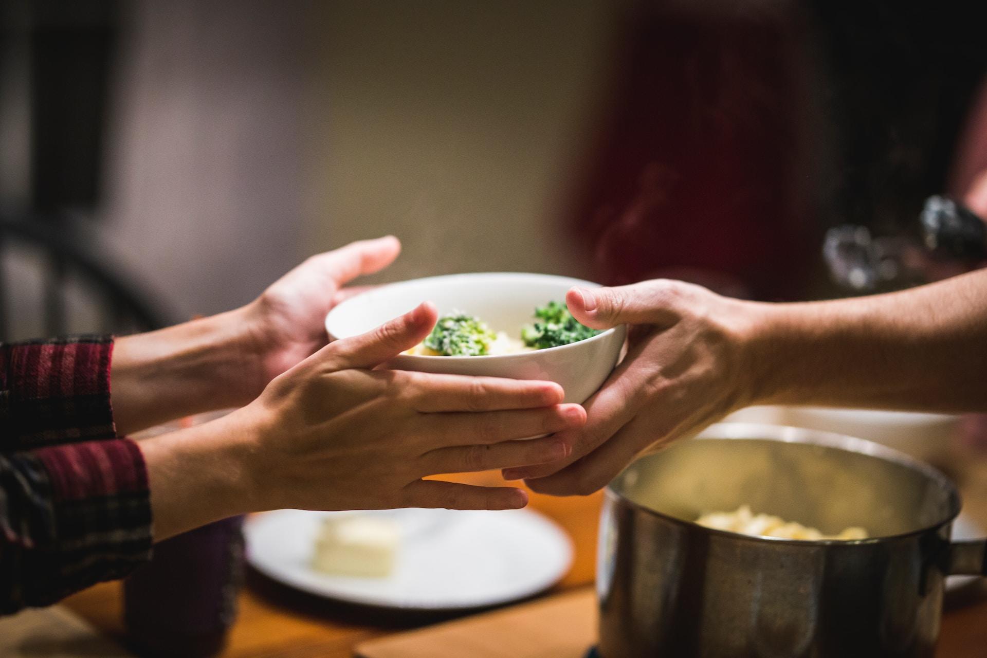 Handing a bowl.