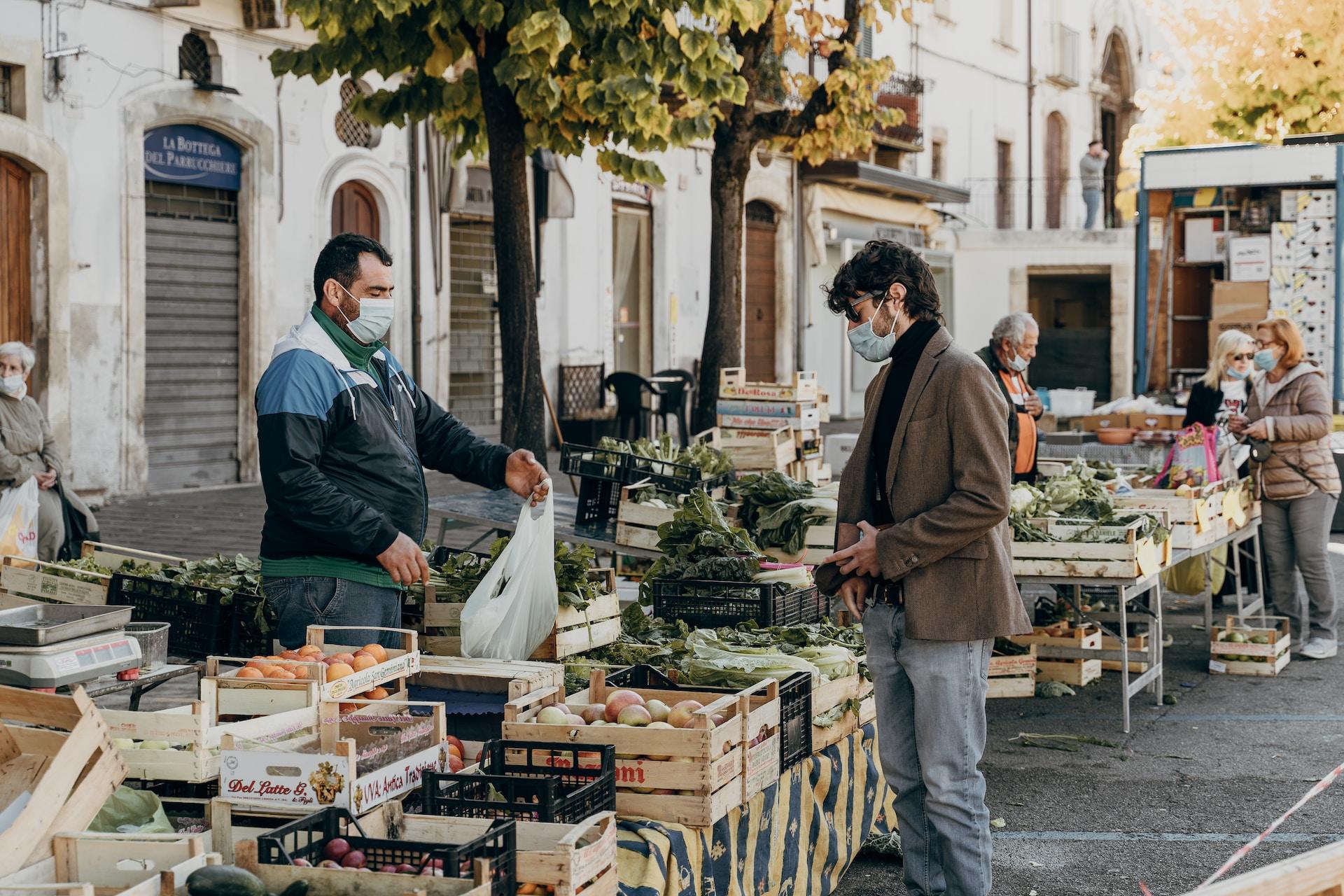 Merchant and customer at an Italian market.