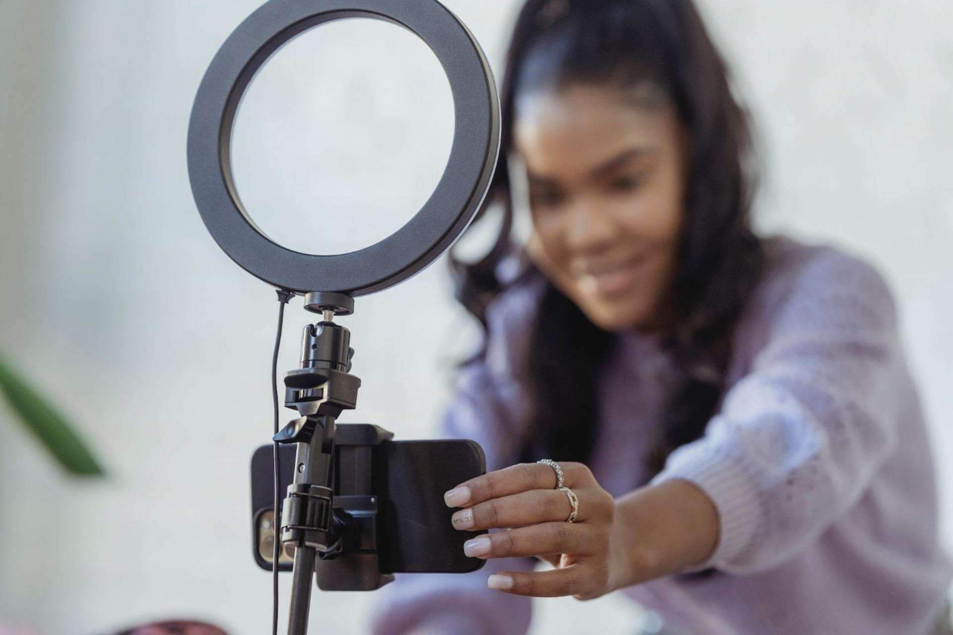 Woman setting up her phone on a tripod before going live