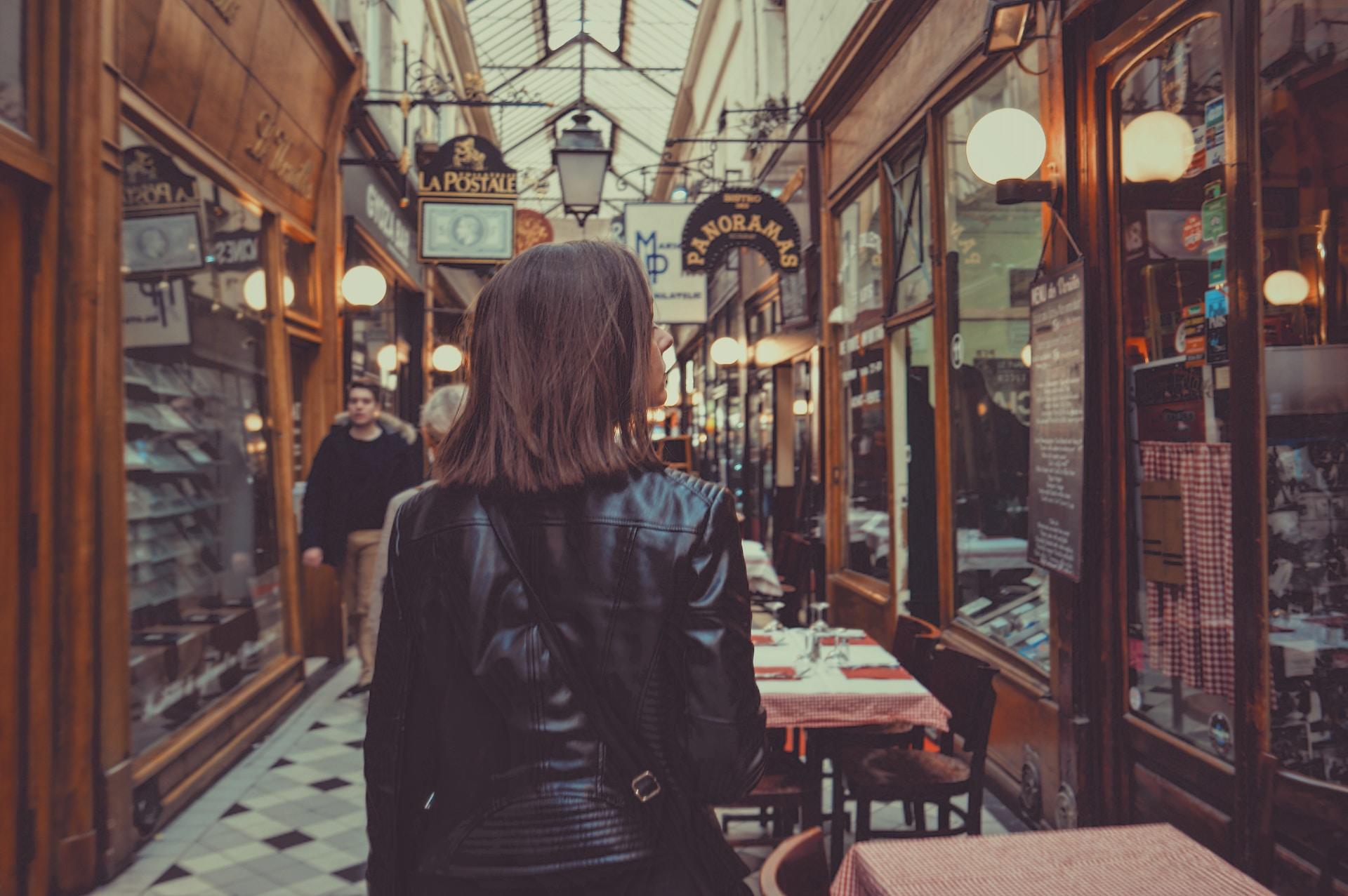 A woman walking through a passage in France