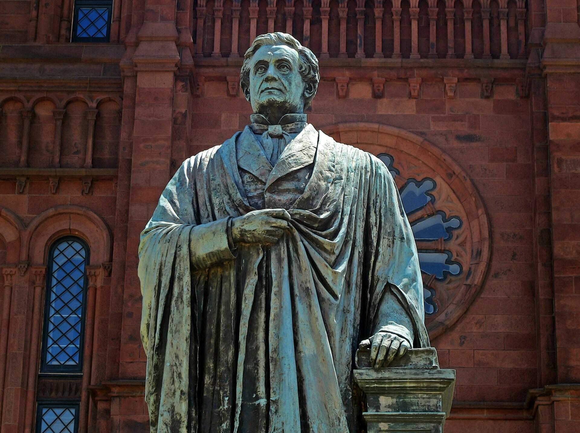 A statue of American scientist and inventor Joesph Henry outside a Smithsonian Institute building in Washington, DC, USA.
