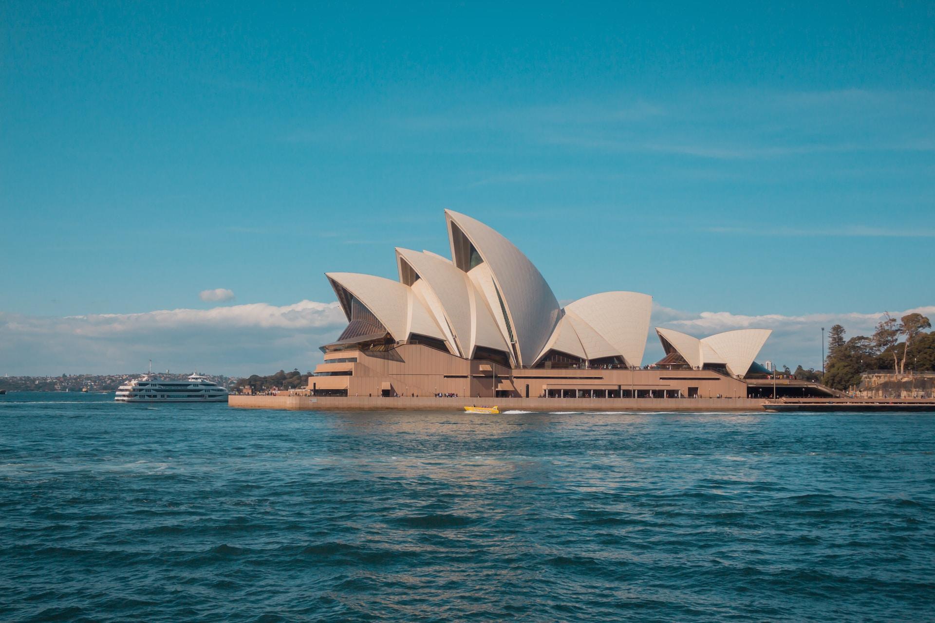 A view of the Sydney Opera House across the water.