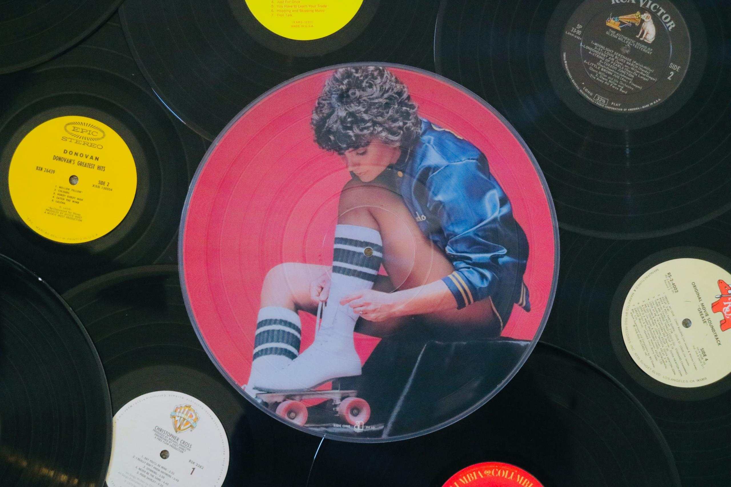 A photo of someone putting on their roller skates on vinyl.