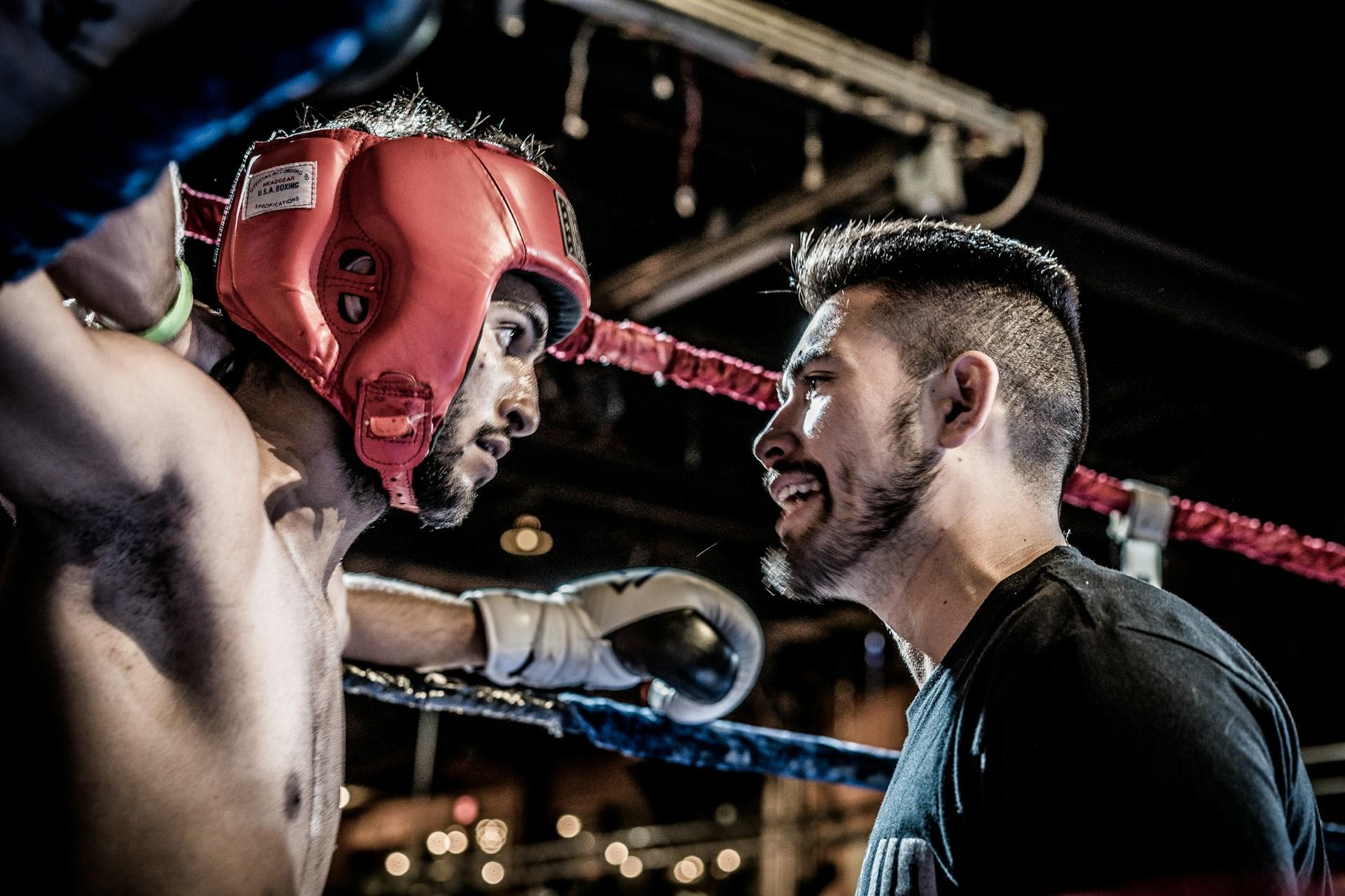 A boxer and their coach during a boxing match.