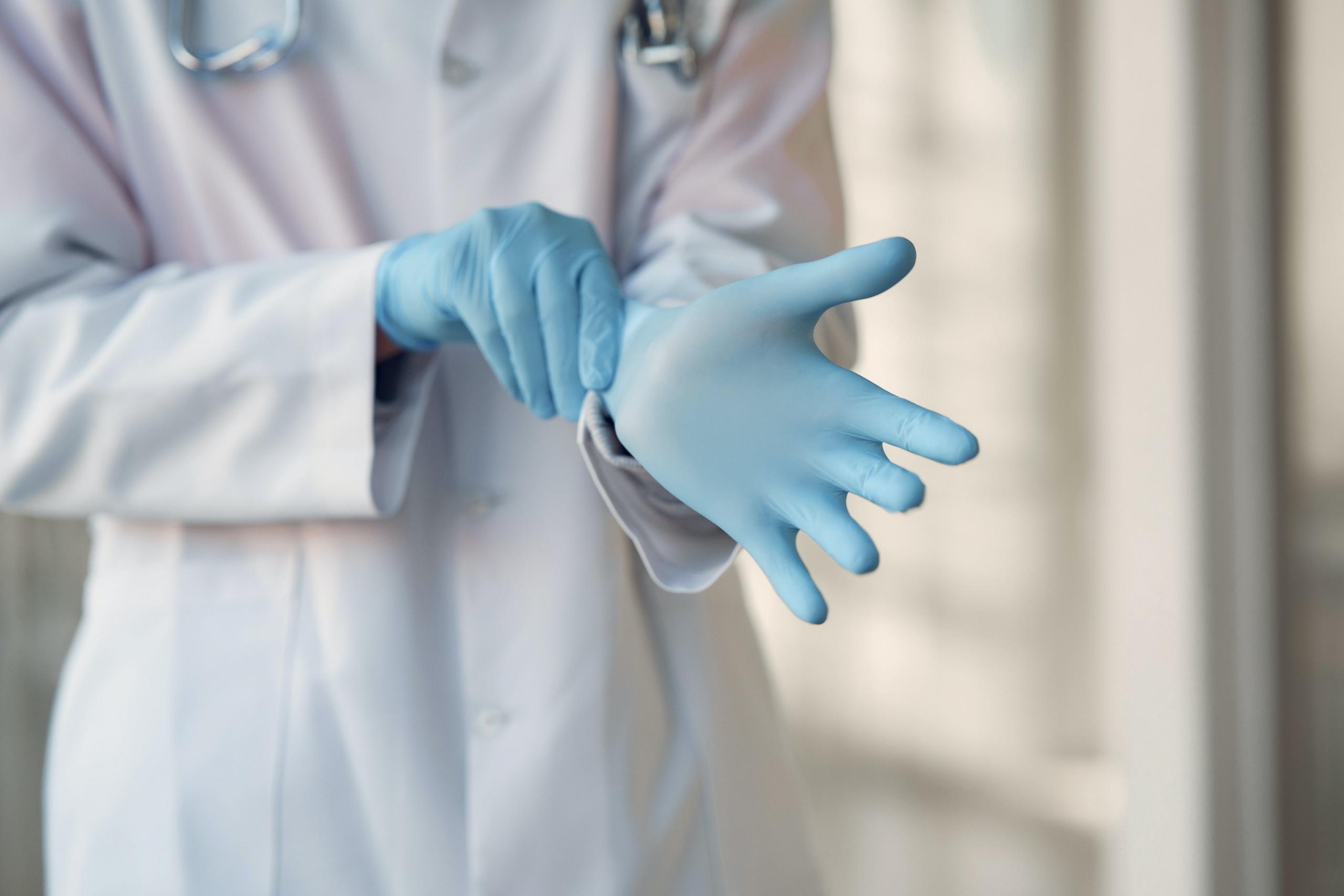 A nurse pulling their glove.