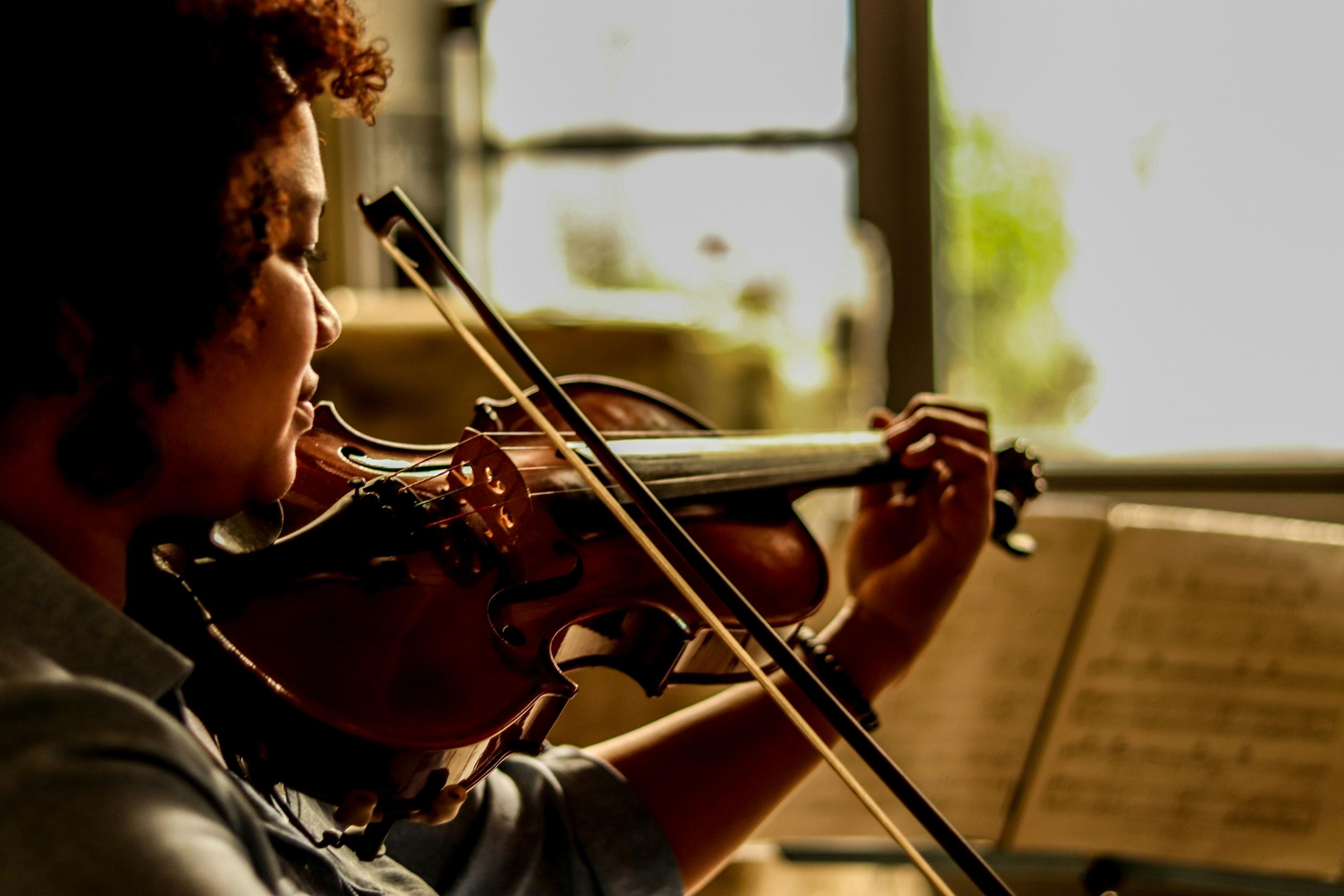 A women learning to play the violin.