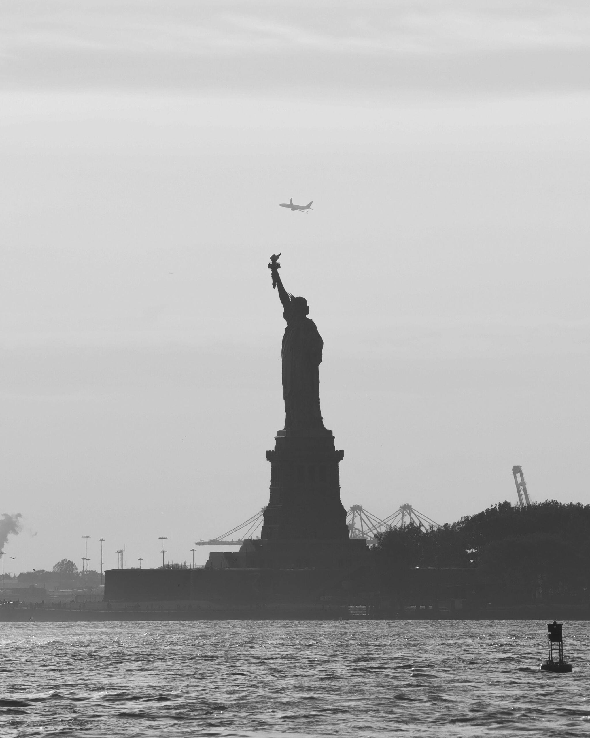 View of the Statue of Liberty from Ellis Island with the New York City skyline in the background.