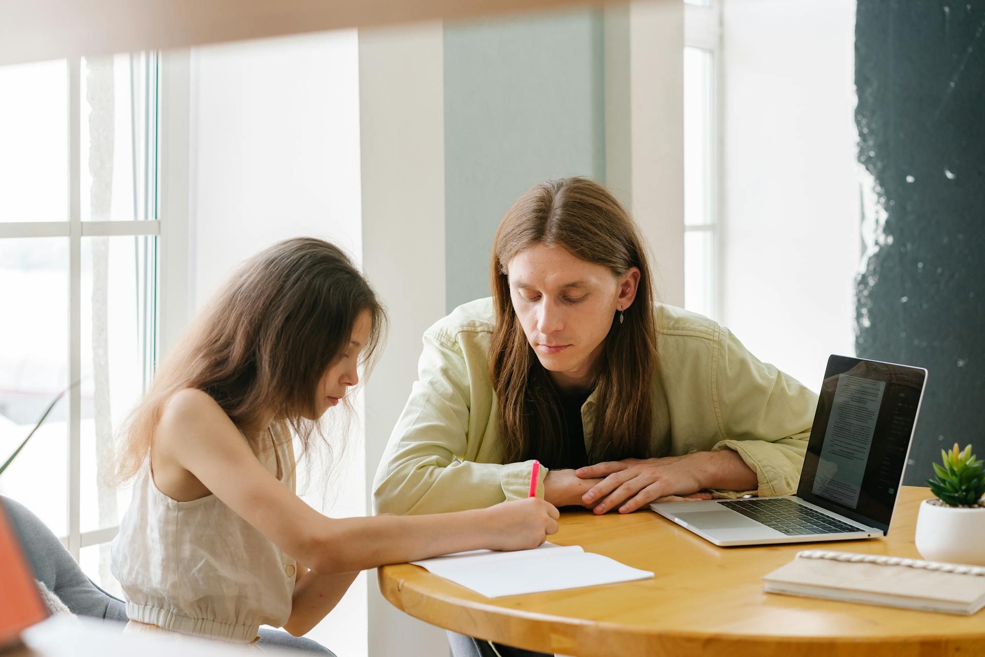 A university student helping tutor a classmate.