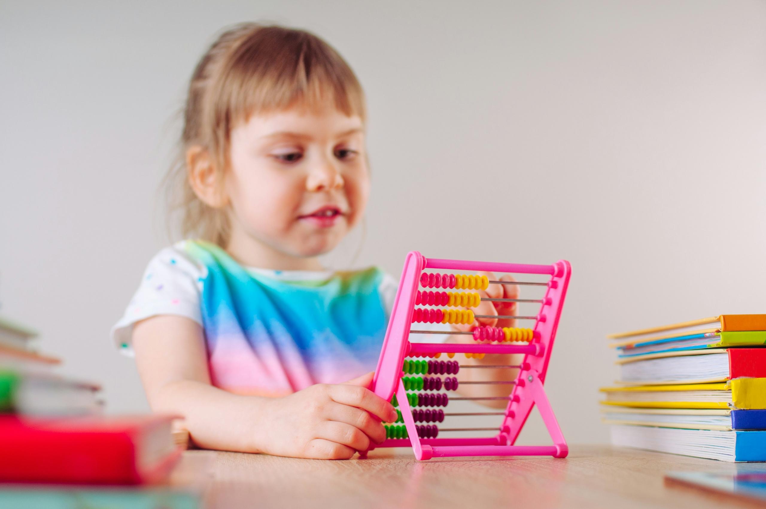 A child playing with an abacus.