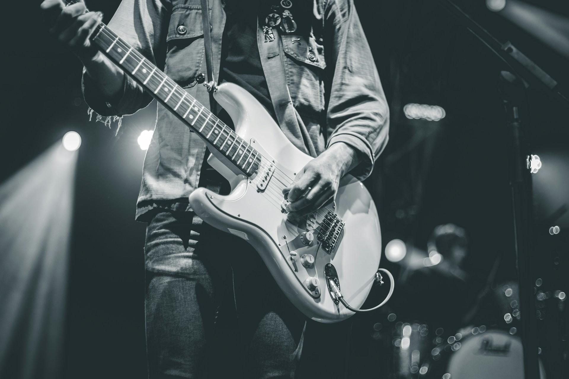 Someone playing the guitar.
