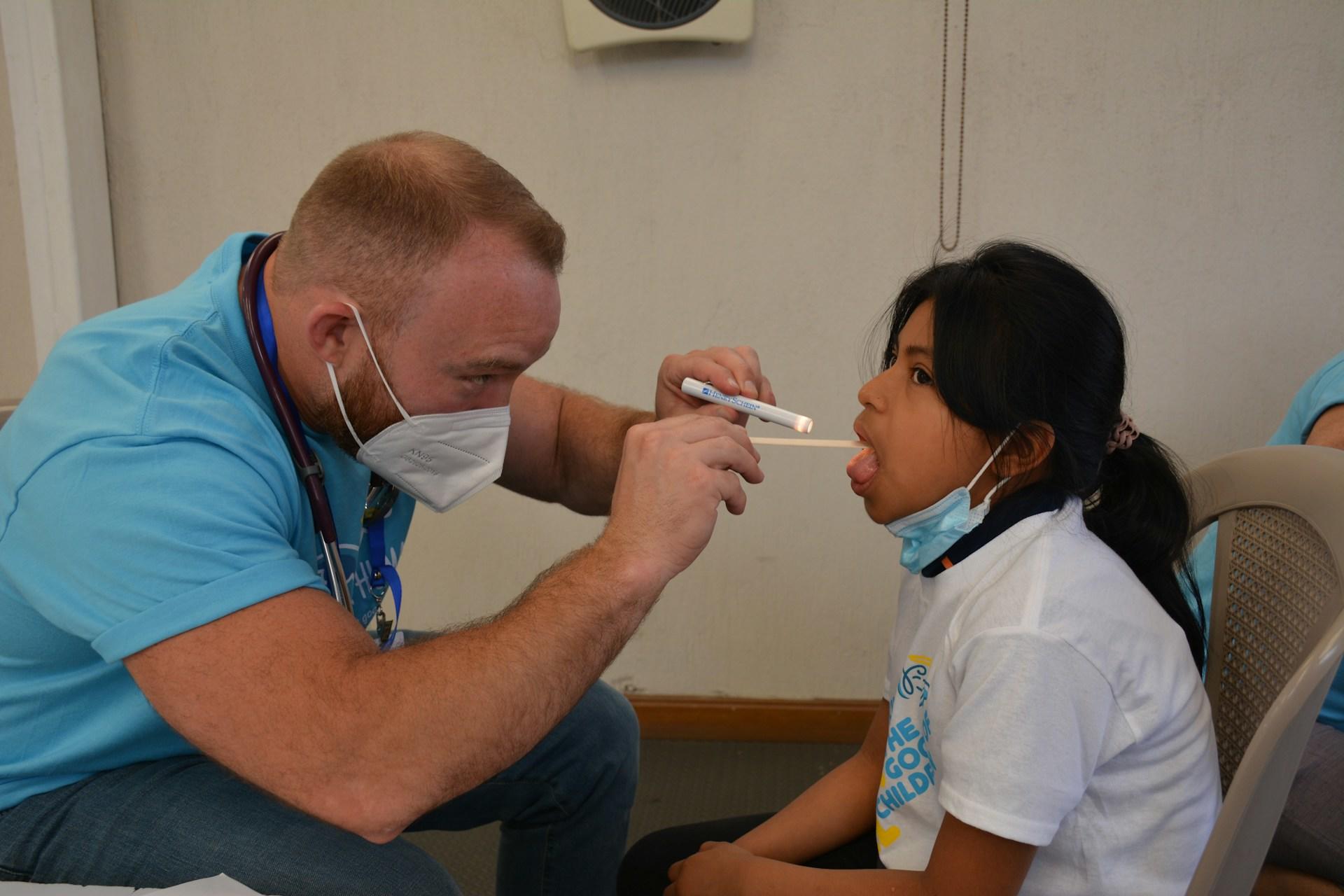 A nurse checking up a child.